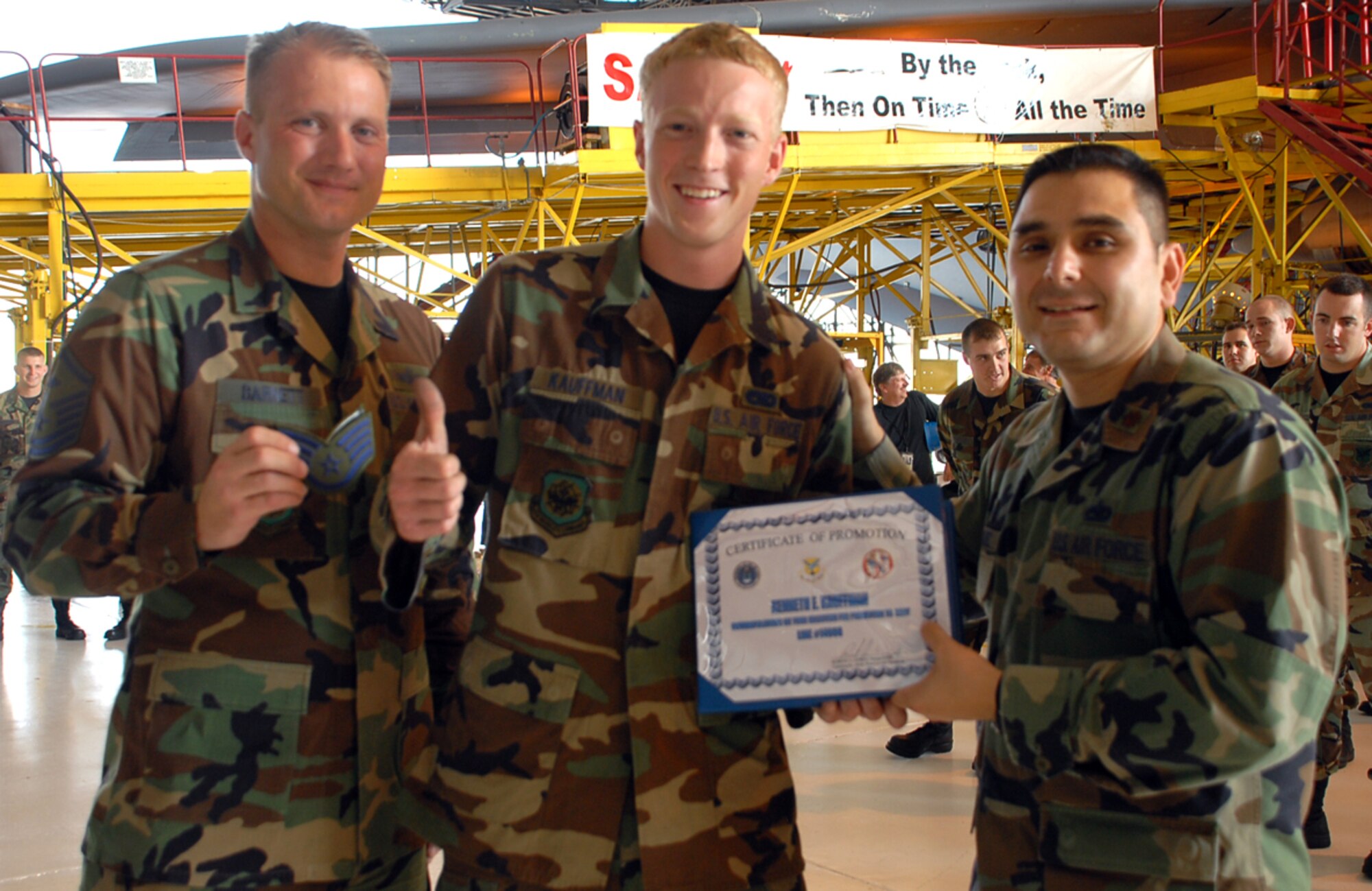 (Center) Senior Airman Kenneth Kauffman, 436th Maintenance Squadron crew chief and new staff sergeant 'selectee,' is ceremoniously presented stripes and his selection for promotion certificate by Master Sgt. Jerry Barnett, 436th MXS first sergeant, and Maj. Robert Gomez, 436th MXS commander, Wednesday. (U.S. Air Force photo/Airman Shen-Chia Chu)