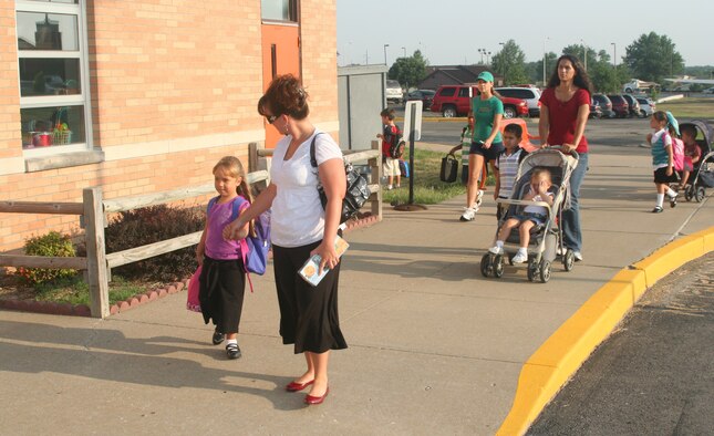 WHITEMAN AIR FORCE BASE, Mo. -- Mary Gunn walks with her daughter, Faith, as they prepare for the first day of school at Whiteman Elementary School Aug. 16. The school would like to remind parents and motorists to help them make this another safe school year. For more information, call 563-3028. (U.S. Air Force photo/Staff Sgt. Rob Hazelett)