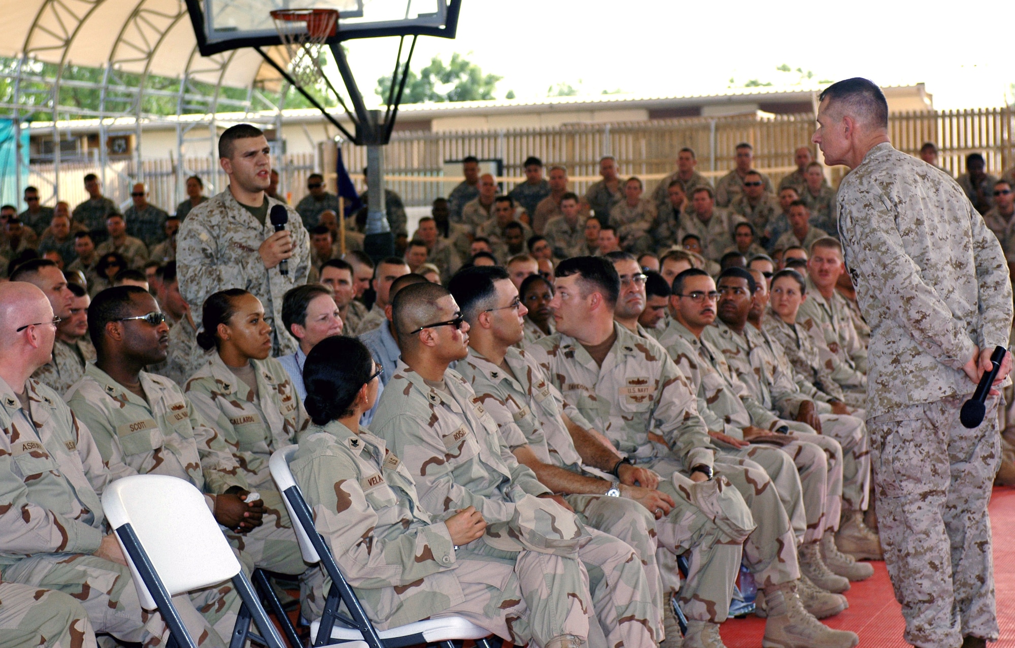 Chairman of the Joint Chiefs of Staff Marine Gen. Peter Pace listens to Marine Lance Cpl. Anthony Comforti ask a question during a Town Hall Meeting Aug. 14 at Camp Lemonier, Djibouti. The general answered questions, shook hands and talked with servicemembers during his morale visit to Camp Lemonier. Through a humanitarian mission of capacity building and military training to help Africans help themselves, Combined Joint Task Force - Horn of Africa members conduct operations such as well-drilling, school construction, medical and veterinary civic action programs and military-to-military training. (U.S. Army photo/Sgt. Brandon McCarty)
