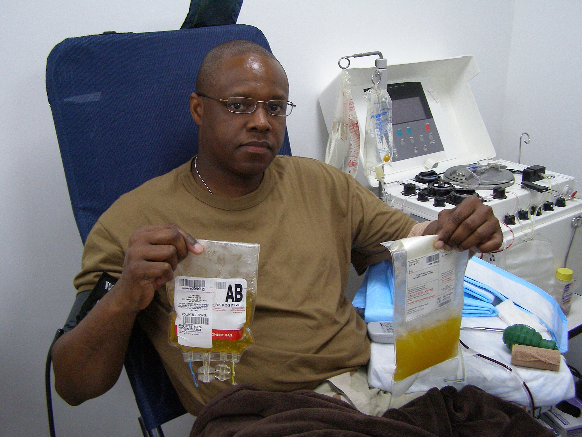 BALAD AIR BASE, Iraq -- Tech. Sgt. Darrin Sewer, 332nd Expeditionary Communications Squadron help desk non-commissioned officer in charge, sits in the donor's chair at the Air Force Theater Hospital's Apheresis Center here Aug. 5, after donating the first plasma in the area of responsibility. Sergeant Sewer has type AB plasma, the universal plasma type. The plasma will be used to supplement current supplies that are sent from the states. (U.S. Air Force courtesy photo)