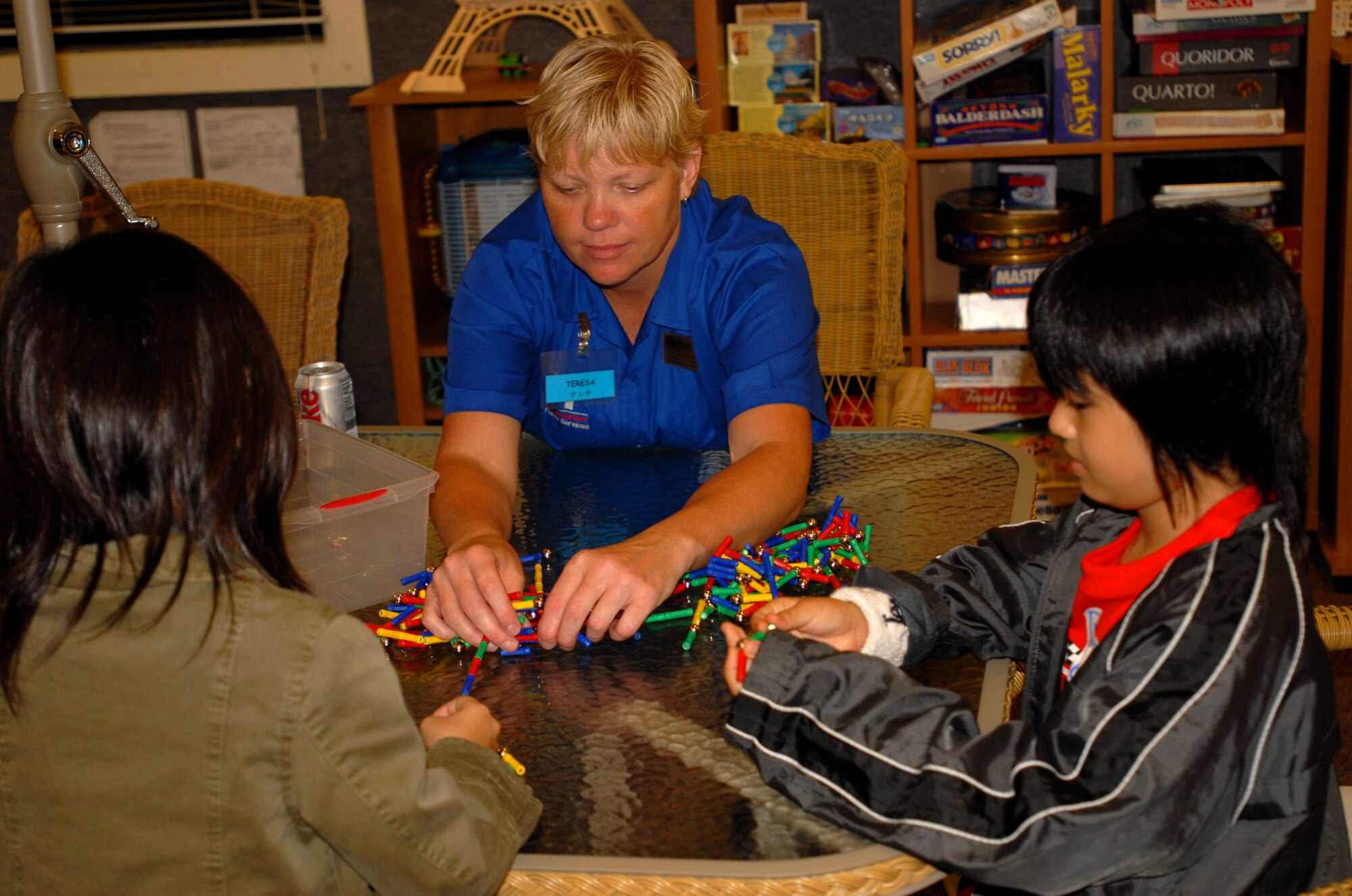 Teresa Witschen (center), 18th Services Squadron youth center manager, plays with Okinawan children during the Kadena and Chatan Town lock-in cultural exchange Aug. 10. The lock-in, which began at 8 p.m. and lasted until 8 a.m. the next day, was organized by the 18th SVS youth center staff and the Chatan Lion's Club. 
(U.S. Air Force photo/Senior Airman Nestor Cruz)