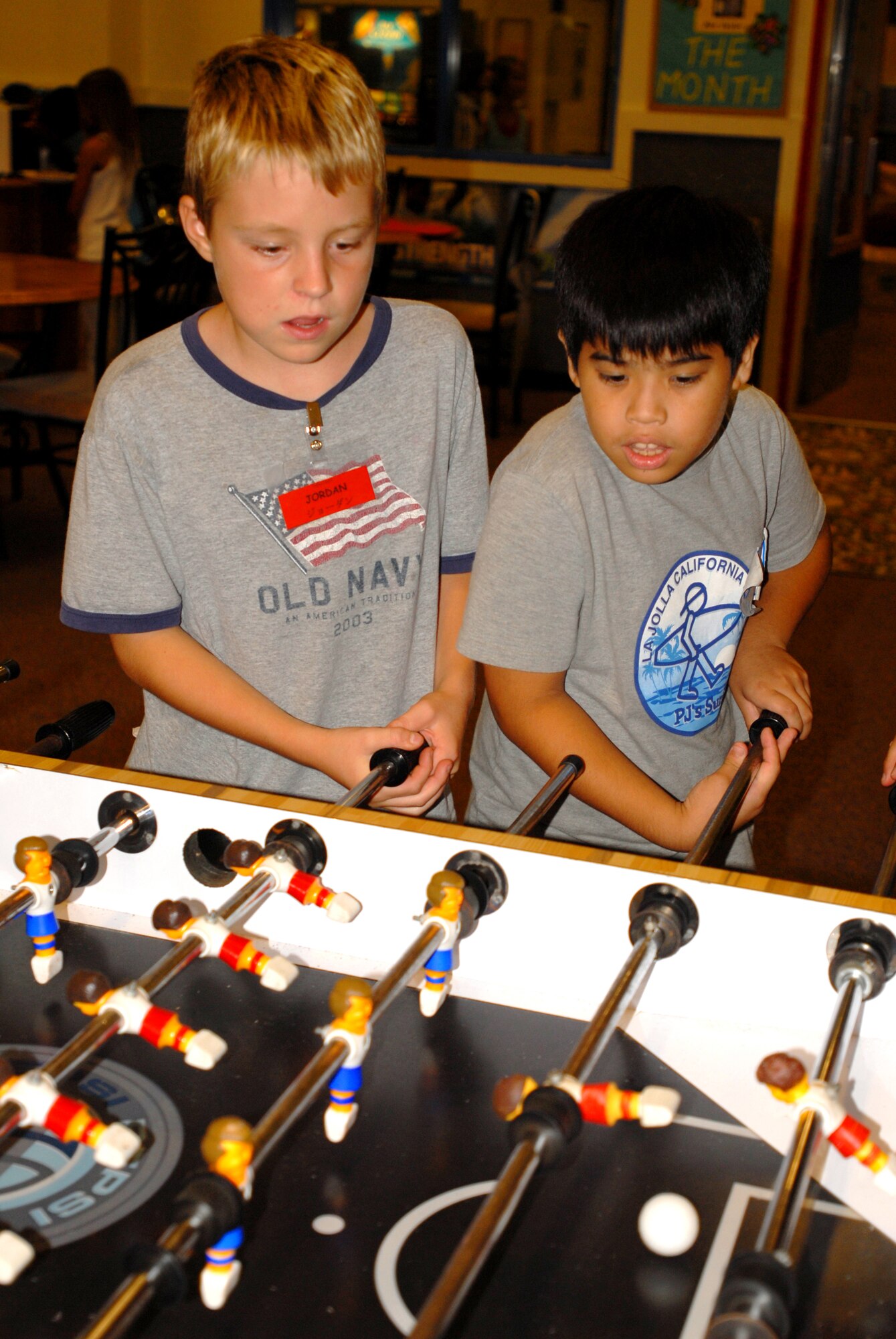 Jordan Holliday (left), son of Army Sgt. 1st Class Anton Engelmann, 1-1 Special Forces Group, Torii Station, teams up with Ryouji Takamine, one of the Okinawan children sponsored by the Chatan Lion’s Club, for a game of foosball during the Kadena and Chatan Town lock-in cultural exchange Aug. 10. The 18th Services Squadron youth center staff and the Chatan Lion’s Club organized the event, which began at 8 p.m. and lasted until 8 a.m. the next day. 
(U.S. Air Force photo/Senior Airman Nestor Cruz)