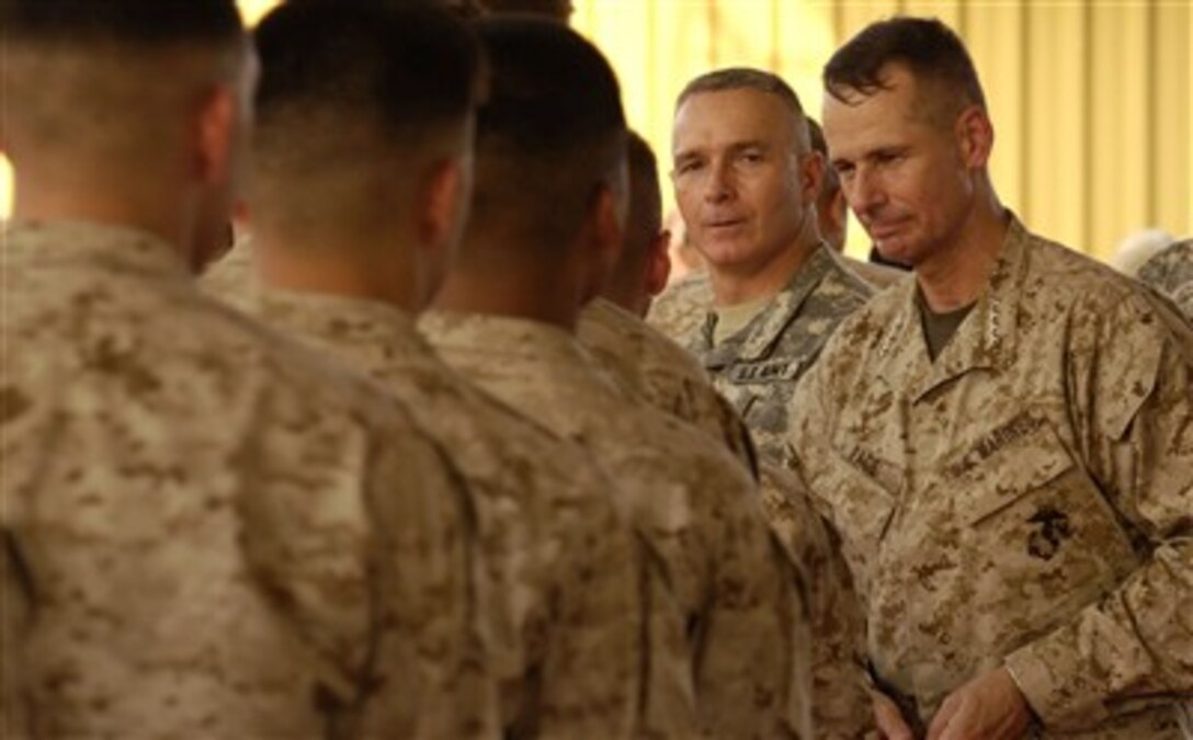 Marines from the 6th Provisional Security Company thank Chairman of the Joint Chiefs of Staff U.S. Marine Gen. Peter Pace (right)  and Senior Enlisted Advisor to the Chairman of the Joint Chiefs of Staff U.S. Army Command Sgt. Maj. William Gainey (2nd from right) for visiting Camp Lemonier, Djibouti, Aug. 14, 2007. 