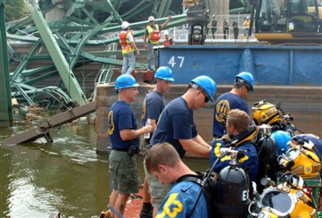 Navy divers from Mobile Diving and Salvage Unit 2 prepare to conduct a dive, Aug. 15,  into the Mississippi River to tie up concrete that fell in during the I-35 Bridge collapse in Minneapolis. 