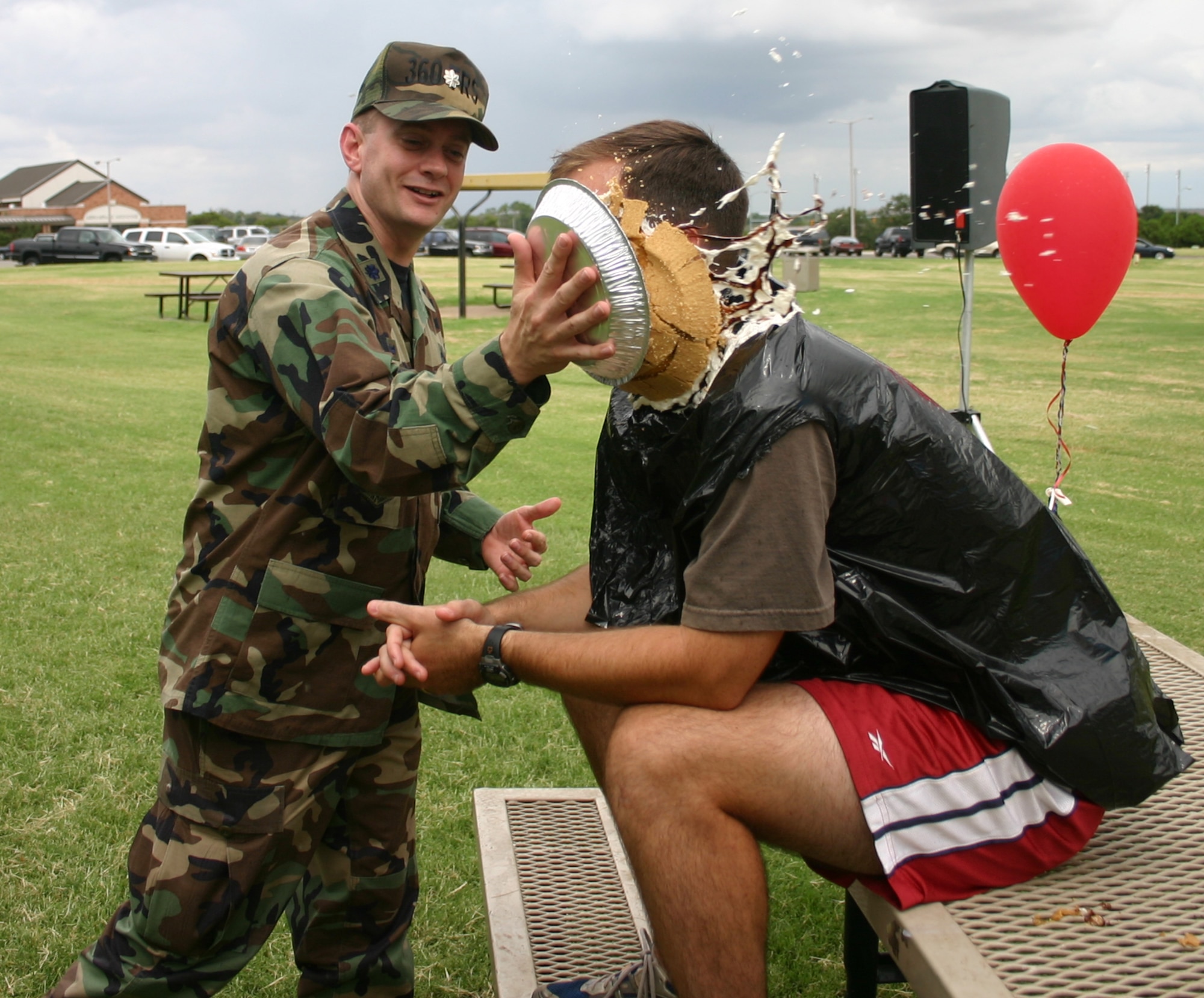 Tech. Sgt. Robert Fraley, 360th Training Squadron, calmly takes a pie in the face from his squadron commander, Lt. Col. Glenn Roberts, at the Enlisted Appreciation Day cookout Aug. 17.  (U.S. Air Force photo/Staff Sgt. Tonnette Thompson)