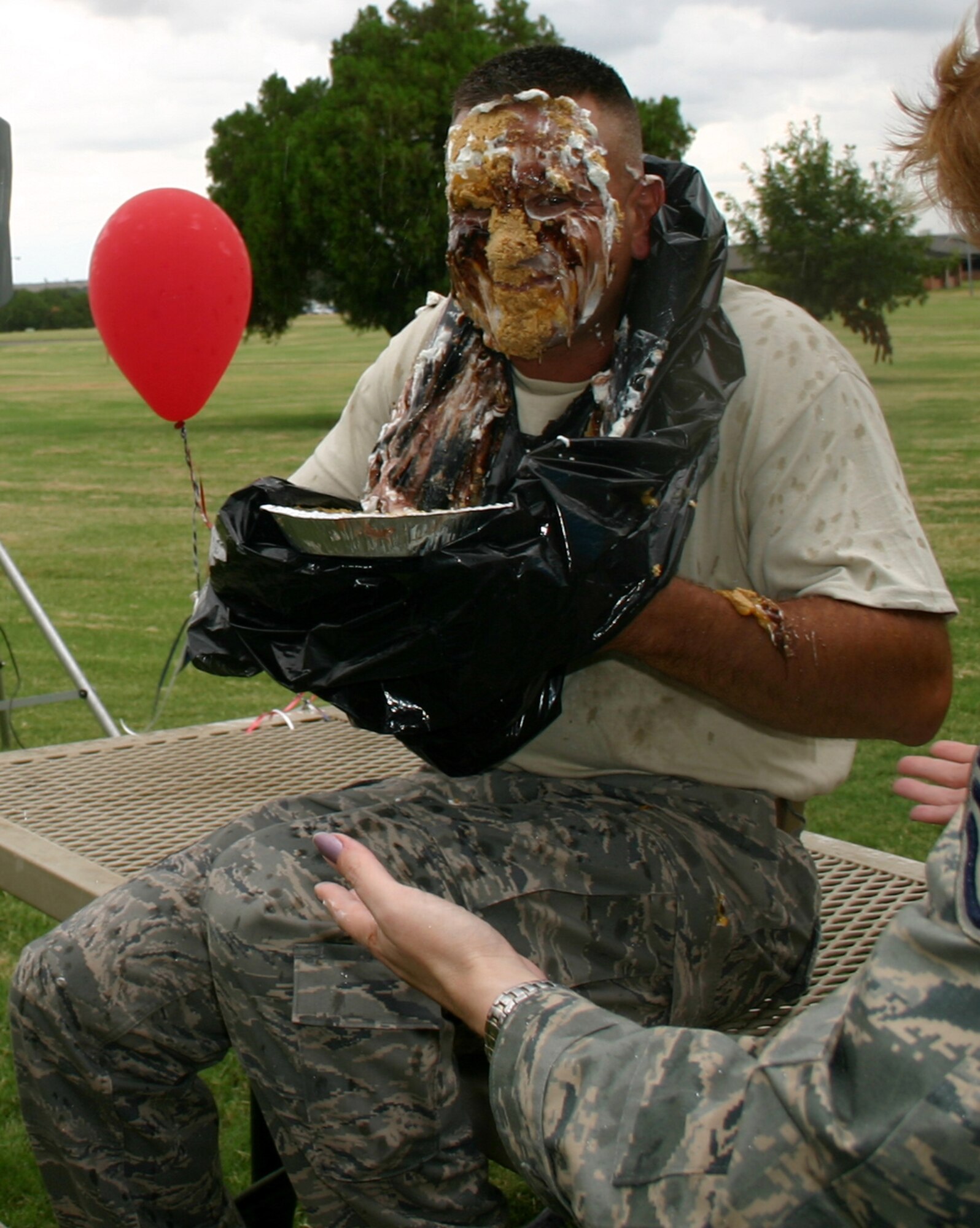 Chief Master Sgt. John Wilson, 361st Training Squadron, smiles for the cameras after receiving a pie in the face at the Enlisted Appreciation Day cookout Aug. 17. The privilege of throwing a pie in Chief Wilson's face earned the highest bid of the day, $85, from 361st TRS commander Lt. Col. Kelly Scott. Proceeds, which exceeded $1,000, go toward Sheppard's upcoming Air Force 60th dance. (U.S. Air Force photo/Staff Sgt. Tonnette Thompson)