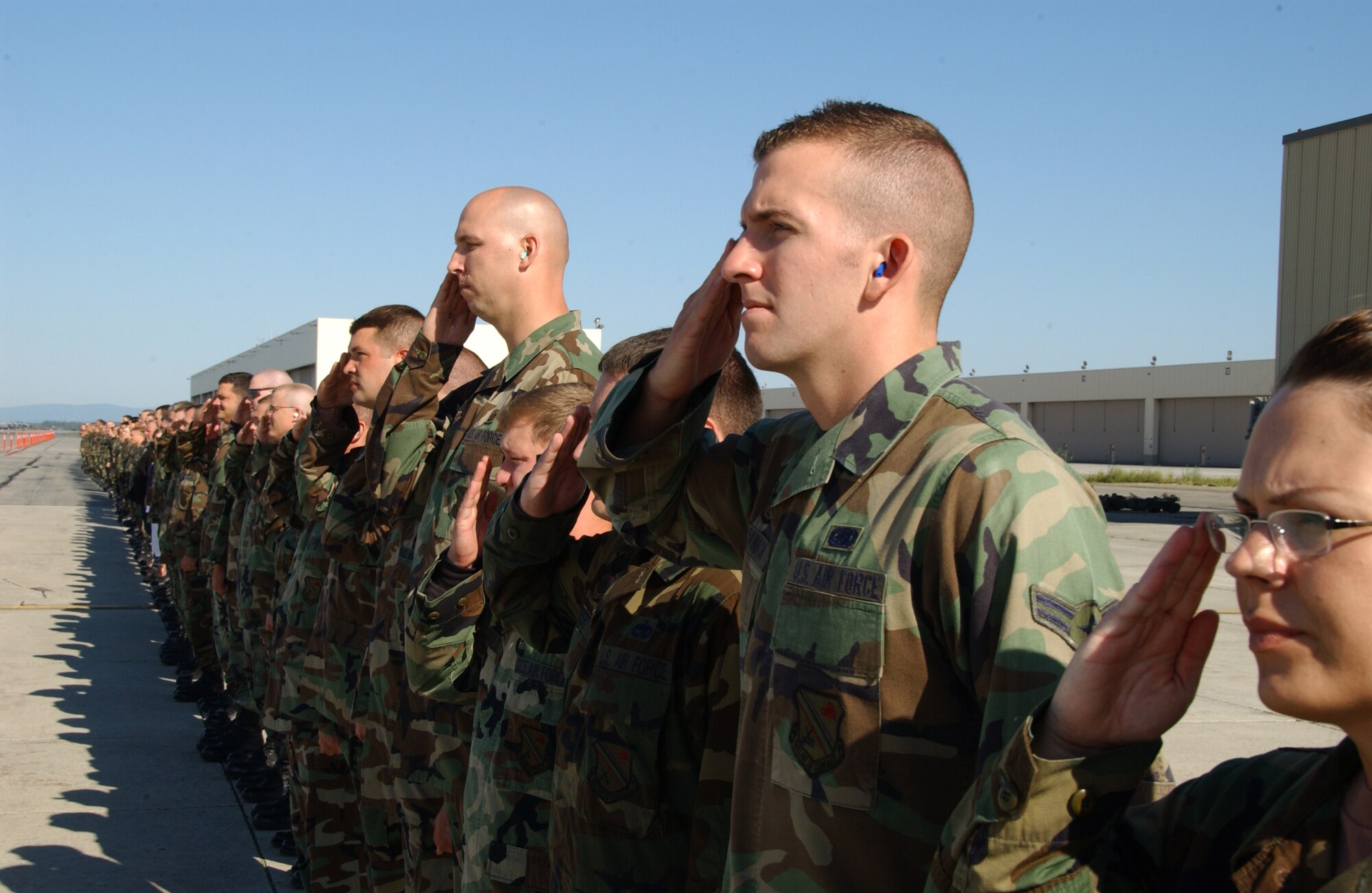 EIELSON AIR FORCE BASE, Alaska --  Airmen of the Iceman team salute Brig. Gen. Dave Scott, 354th Fighter Wing commander, arriving from his finni flight greeting him with over a hundred person salute Aug. 17, 2007. During the Fighter Wing cookout Gen. Scott taxied by after landing from his final flight at Eielson AFB, to be greeted with over a hundred salutes.  (U.S. Air Force photo by Airman 1st Class Christopher Griffin)