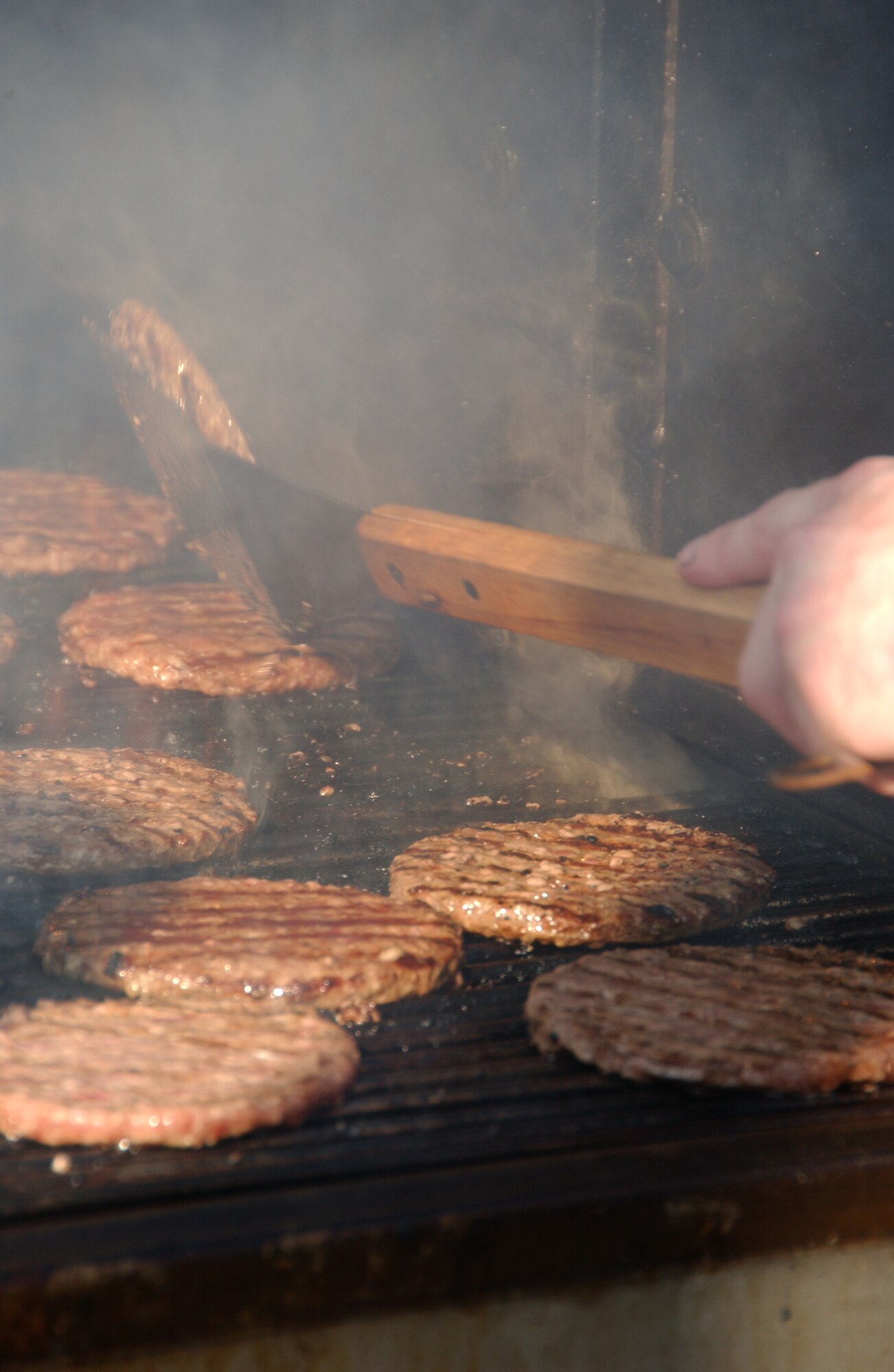 EIELSON AIR FORCE BASE, Alaska -- A hamburger being prepared over a barbeque for the Fighter Wing cook out Aug. 17, 2007. The cookout was held to show appreciation for all the hard work the Iceman team does year round and also for Brig. Gen. Dave Scott, 354th Fighter Wing commander, to show his thanks to all of the airmen of the 354th Fighter Wing.  (U.S. Air Force photo by Airman 1st Class Christopher Griffin)