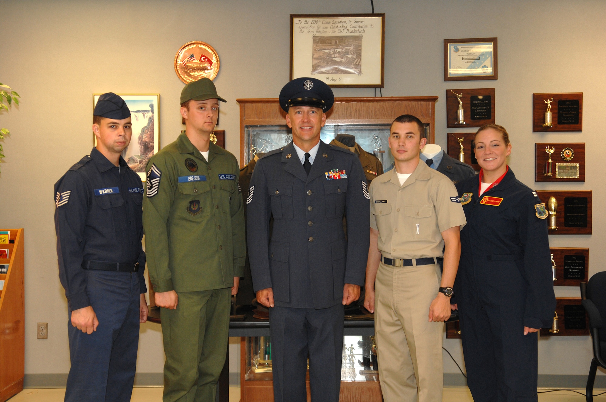 MINOT AIR FORCE BASE, N.D. – Chief Master Sgt. Mark Brejcha (center), 91st Space Wing command chief, and members from the Team Minot 5/6 Living Legends group, made up of Airmen from the 5th Bomb Wing and 91st SW, wear historical Air Force uniforms while carrying out their daily duties and tell the story of the Airmen who wore those uniforms. (U.S. Air Force photo by Senior Airman Stacey Moless)