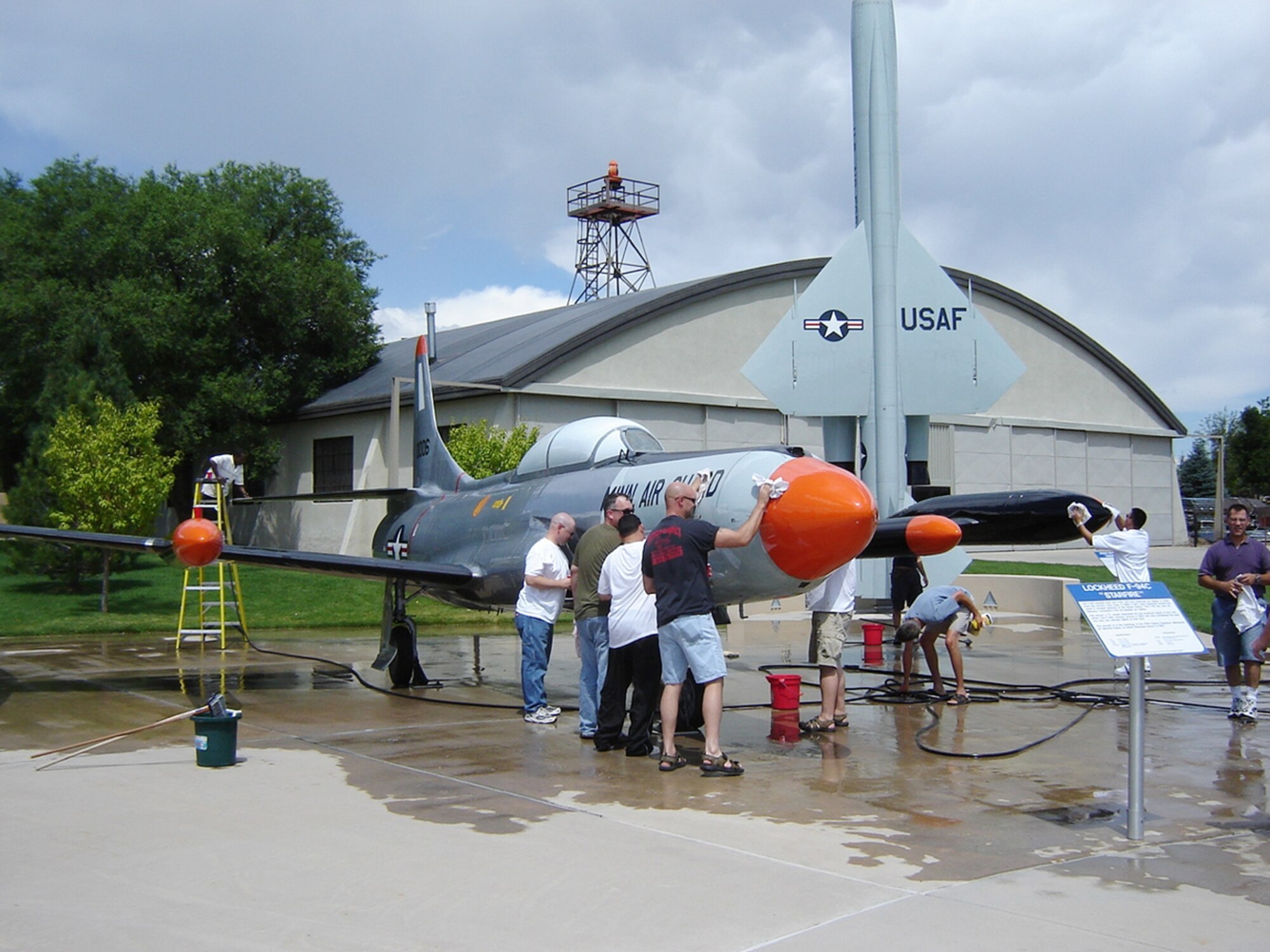 Airmen from the 21st Operations Support Squadron banded together to give the F-94 "Starfire" a thorough cleaning on Aug.10 as part of the Adopt-A-Plane program.  The F-94 was the host of many firsts:  first U.S. fighter without guns; first non-experimental straight-winged aircraft to break the sound barrier; first to employ a drag chute and to use the Hughes automatic fire control system; and the first U.S. radar detected destruction of an enemy plane by an American jet. (Photo by Jeff Nash)