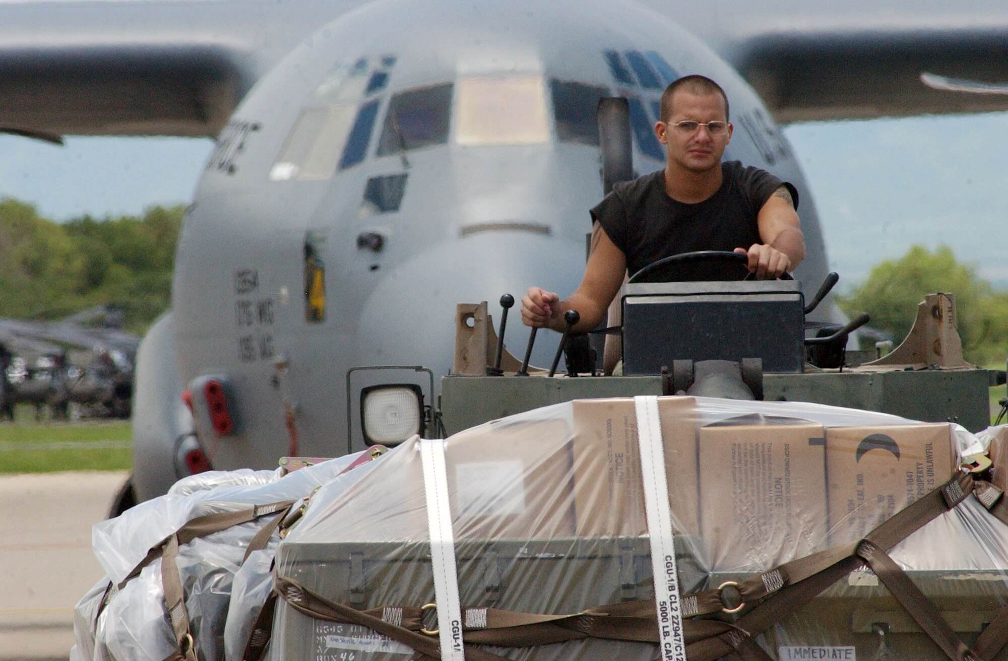 Senior Airman Kenneth Cumbie loads medical supplies onto a C-130 Hercules Aug. 17 at Soto Cano Air Base, Honduras.  Approximately 30 Soldiers and Airmen at are responding to the Aug. 15 earthquake in Peru and are taking 4,470 pounds of medical supplies for relief efforts. Airman Cumbie is assigned to the 612th Air Base Squadron at Soto Cano AB. (U.S. Air Force photo/Tech. Sgt. Sonny Cohrs) 