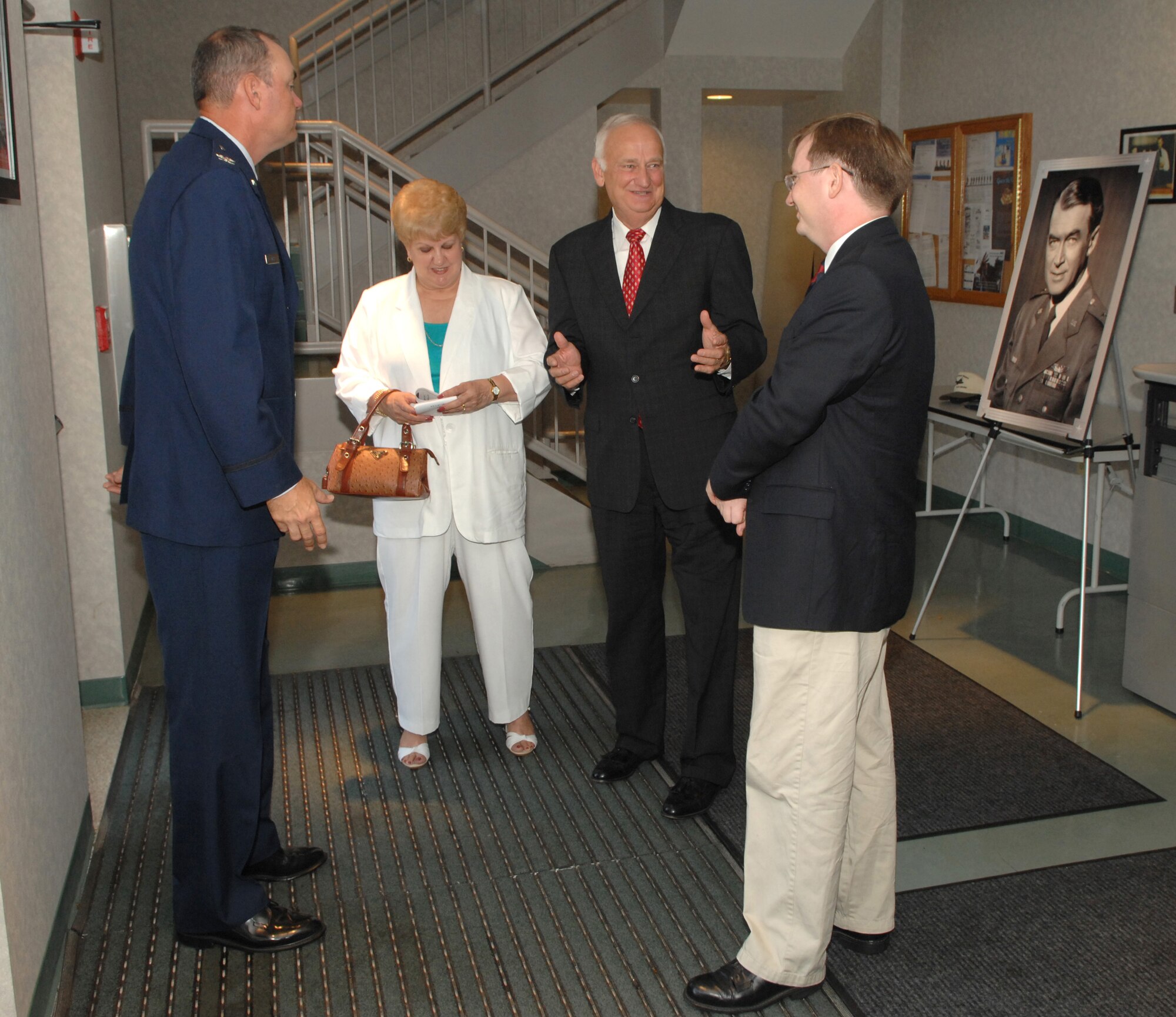 Col. Terry Ross (left),  Peggy Green, Carson Green and Andrew Stephens talk at the Jimmy Stewart Theater Dedication Ceremony Aug. 13 at Building 52 on Bolling Air Force Base, D.C. The theater is named after Brig. Gen. James Stewart who enlisted in the Army Air Corps in 1941 and rose to the rank of colonel in four years. At the time of his enlistment, Mr. Stewart was a famous actor with an Academy Award to his name. Colonel Ross is the 11th Wing vice commander, Mr. Green is the president of the Jimmy Maitland Stewart Museum, and Mr. Stephens is the 11th Wing historian. (U.S. Air Force photo/Airman 1st Class Tim Chacon) 
