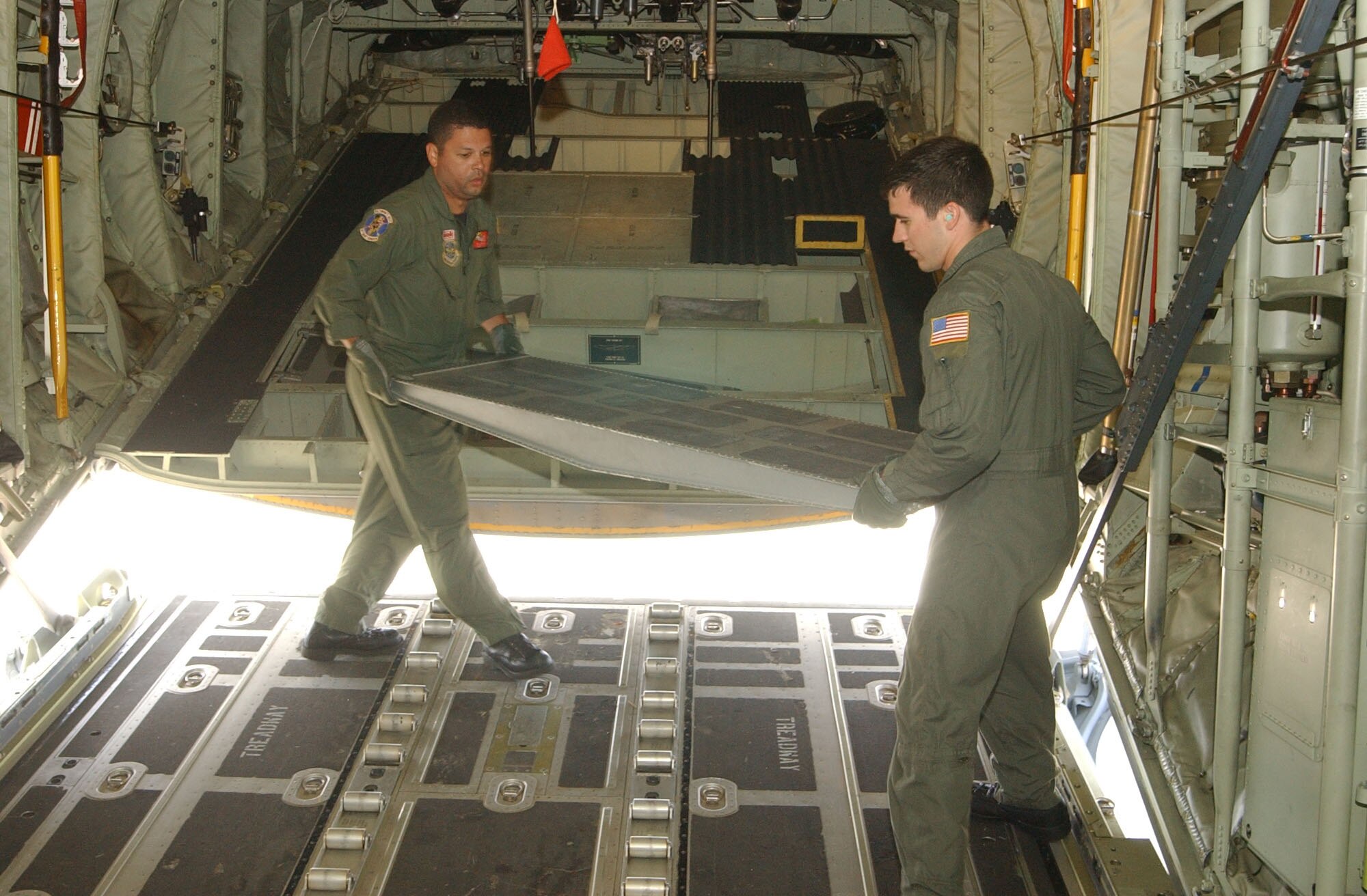 SOTO CANO AIR BASE, Honduras – Senior Airman Brandon Krantz, right, and Tech. Sgt. Will Morales, both loadmasters with the 135th Airlift Squadron, Maryland Air National Guard, configure the interior of a C-130J prior to a relief mission to Peru Aug. 17. The aircrew is taking approximately 30 Soldiers and Airmen who are responding to the Aug. 15 earthquake in Peru and are taking with them 4,470 pounds of medical supplies for relief efforts.  (US Air Force photo by Tech. Sgt. Sonny Cohrs)