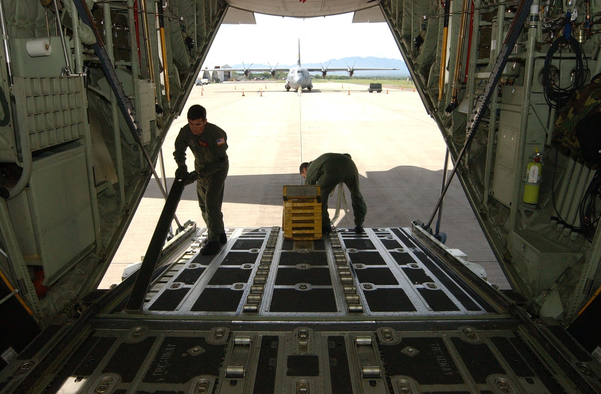 SOTO CANO AIR BASE, Honduras – Senior Airman Brandon Krantz, left, and Tech. Sgt. Will Morales, both loadmasters with the 135th Airlift Squadron, Maryland Air National Guard, configure the interior of a C-130J prior to a relief mission to Peru Aug. 17. Approximately 30 Soldiers and Airmen are responding to the Aug. 15 earthquake in Peru and are taking with them 4,470 pounds of medical supplies for relief efforts.  (US Air Force photo by Tech. Sgt. Sonny Cohrs)