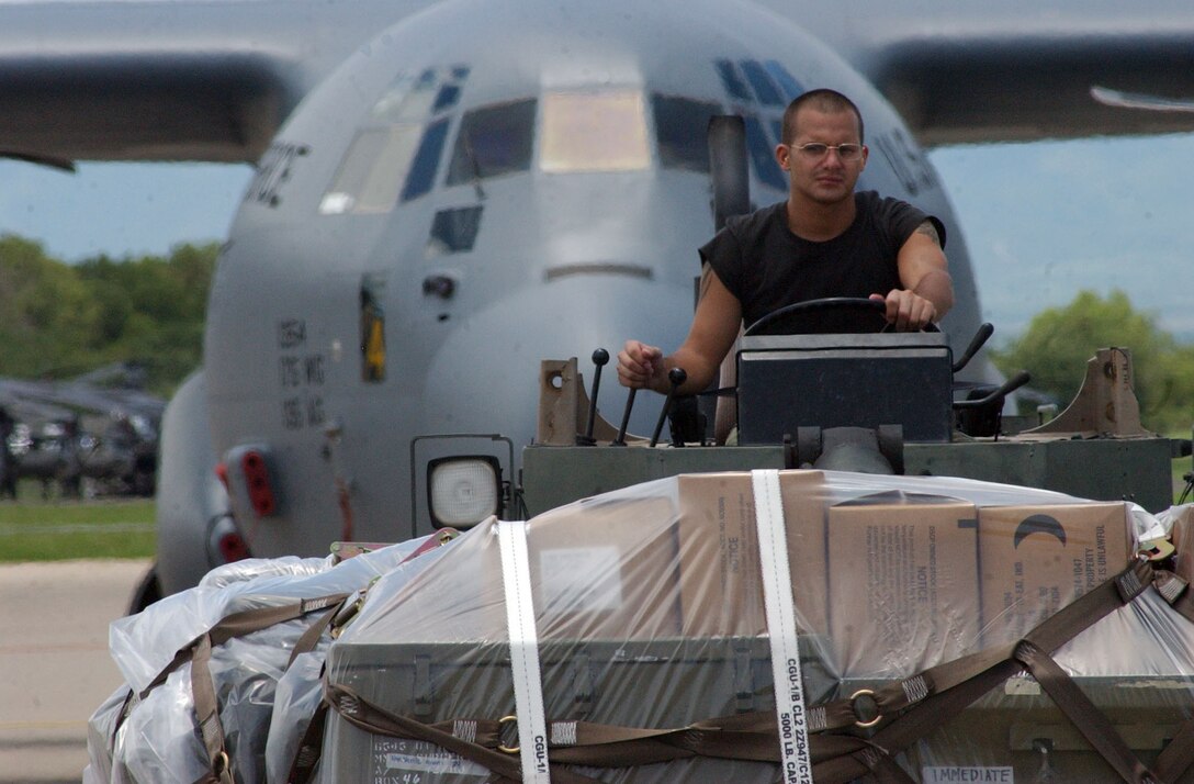 SOTO CANO AIR BASE, Honduras – Senior Airman Kenneth Cumbie, 612th Air Base Squadron here, drives a forklift to load medical supplies onto a C-130J from the Maryland Air National Guard. Approximately 30 Soldiers and Airmen are responding to the Aug. 15 earthquake in Peru and are taking with them 4,470 pounds of medical supplies for relief efforts.  (US Air Force photo by Tech. Sgt. Sonny Cohrs)