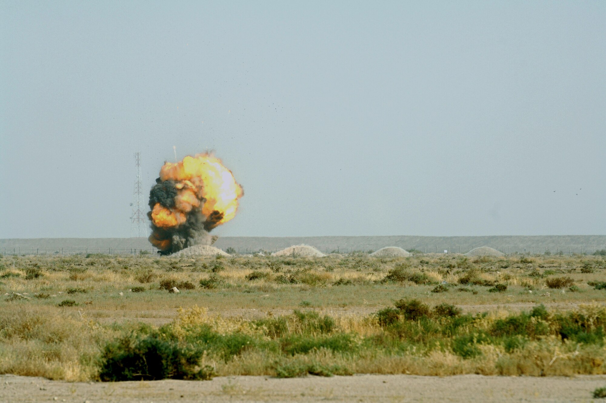 A fire cloud erupts at Ali Air Base, Iraq, as a load of C-4 explosives blow up Aug. 10 during a controlled detonation of confiscated weapons.  The 407th Civil Engineer Squadron's explosive ordnance disposal team disposes of confiscated weapons and unexploded ordnance and trains convoy people to recognize improvised explosive devices. (U.S. Air Force photo/Master Sgt. Robert Valenca) 