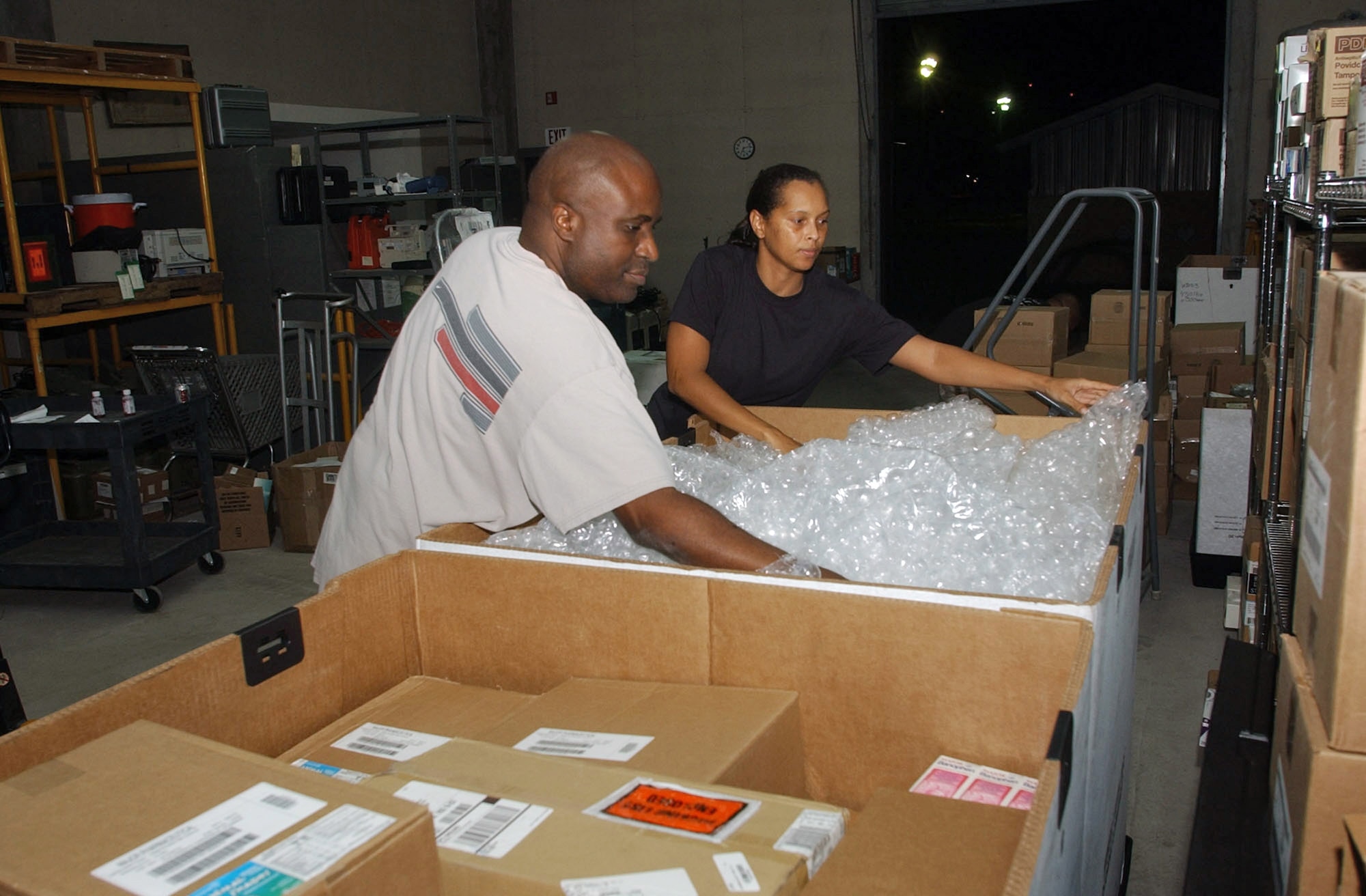 Master Sgt. Michael Freeman and Capt. Ebony Weston pack supplies Aug. 16 at Soto Cano Air Base, Honduras, for the mobile surgical team's deployment to Peru to assist with earthquake relief efforts.  Sergeant Freeman and Captain Weston are part of the Soto Cano medical element.  (U.S. Air Force photo/Tech. Sgt. Sonny Cohrs) 