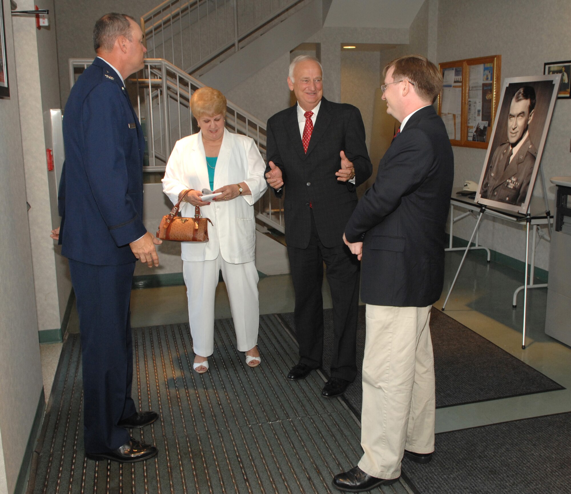 Col. Terry L. Ross (left), 11th Wing vice commander, Peggy Green, Carson Green, president of the Jimmy Maitland Stewart Museum, and Andrew Stephens, 11th Wing historian, talk at Building 52 on Bolling during the dedication of the Jimmy Stewart Theater Aug.13. The theater is named after Brig. Gen. James Stewart who enlisted in the Army Air Corps in 1941 and rose to the rank of colonel in four years. At the time of his enlistment Mr. Stewart was a famous actor with an Academy Award to his name. (U. S. Air Force photo by Airman First Class Tim Chacon)