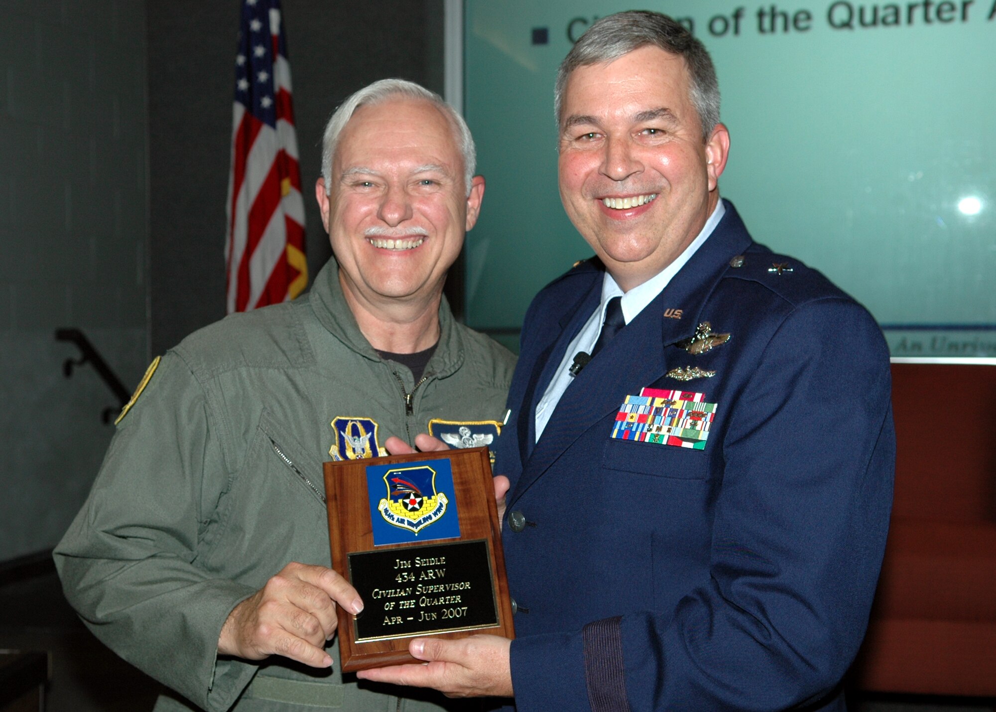 GRISSOM AIR RESERVE BASE, Ind., -- Senior Master Sgt. Jim Seidle, 72nd Air Refueling Squadron, left, receives a plaque from Brig. Gen. Dean Despinoy, 434th Air Refueling Wing commander, for his selection as the Civilian Supervisor of the Quarter, during a civilian commander's call held recently. (U.S. Air Force photo/Tech. Sgt. Doug Hays)