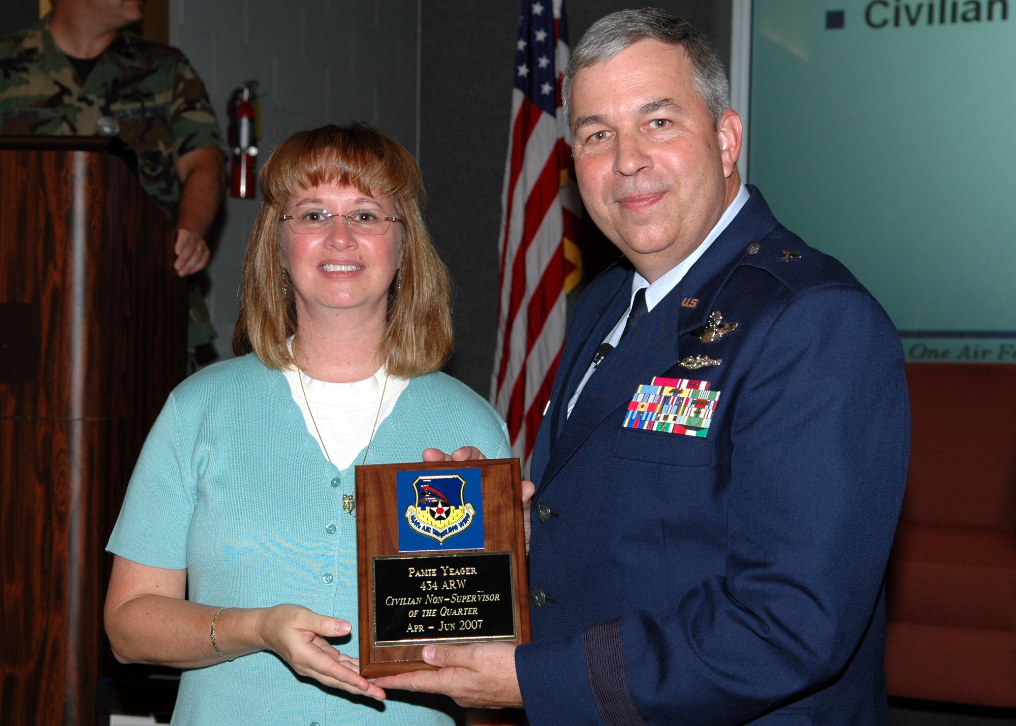 GRISSOM AIR RESERVE BASE, Ind., -- Brig Gen. Dean Despinoy, 434th Air Refueling Wing commander, presents a plaque to Pamie Yeager, civilian personnel office, for her selection as the wing's Civilian Non-Supervisor of the Quarter, during a civilian commander's call held recently. (U.S. Air Force photo/Tech. Sgt. Doug Hays)