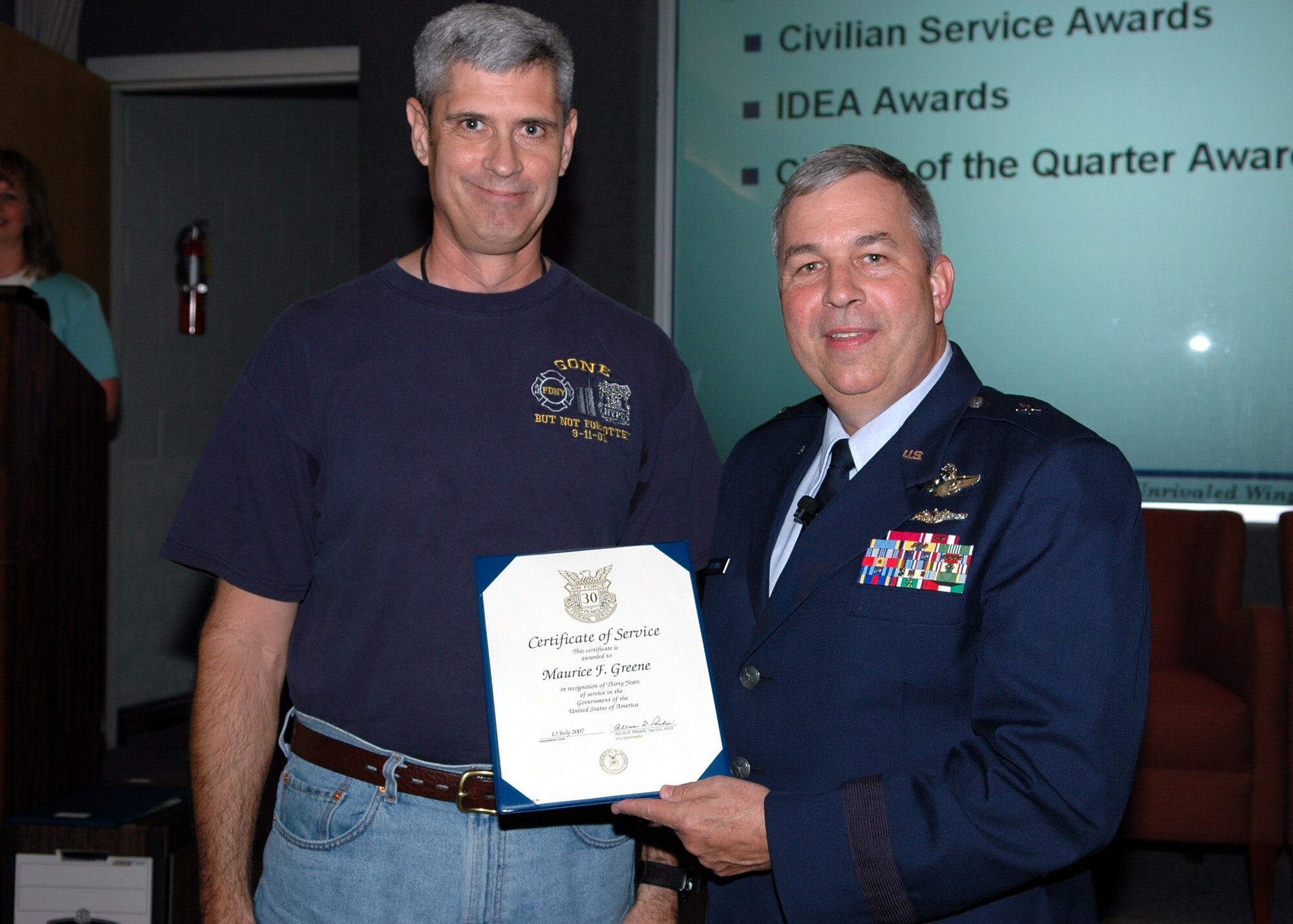 GRISSOM AIR RESERVE BASE, Ind., -- Brig. Gen. Dean Despinoy, 434th Air Refueling Wing commander, right, presents a certificate and pin to Master Sgt. Maurice Greene, 434th  Maintenance Squadron, recognizing his 30 years of federal service. (U.S. Air Force photo/Tech. Sgt. Doug Hays)