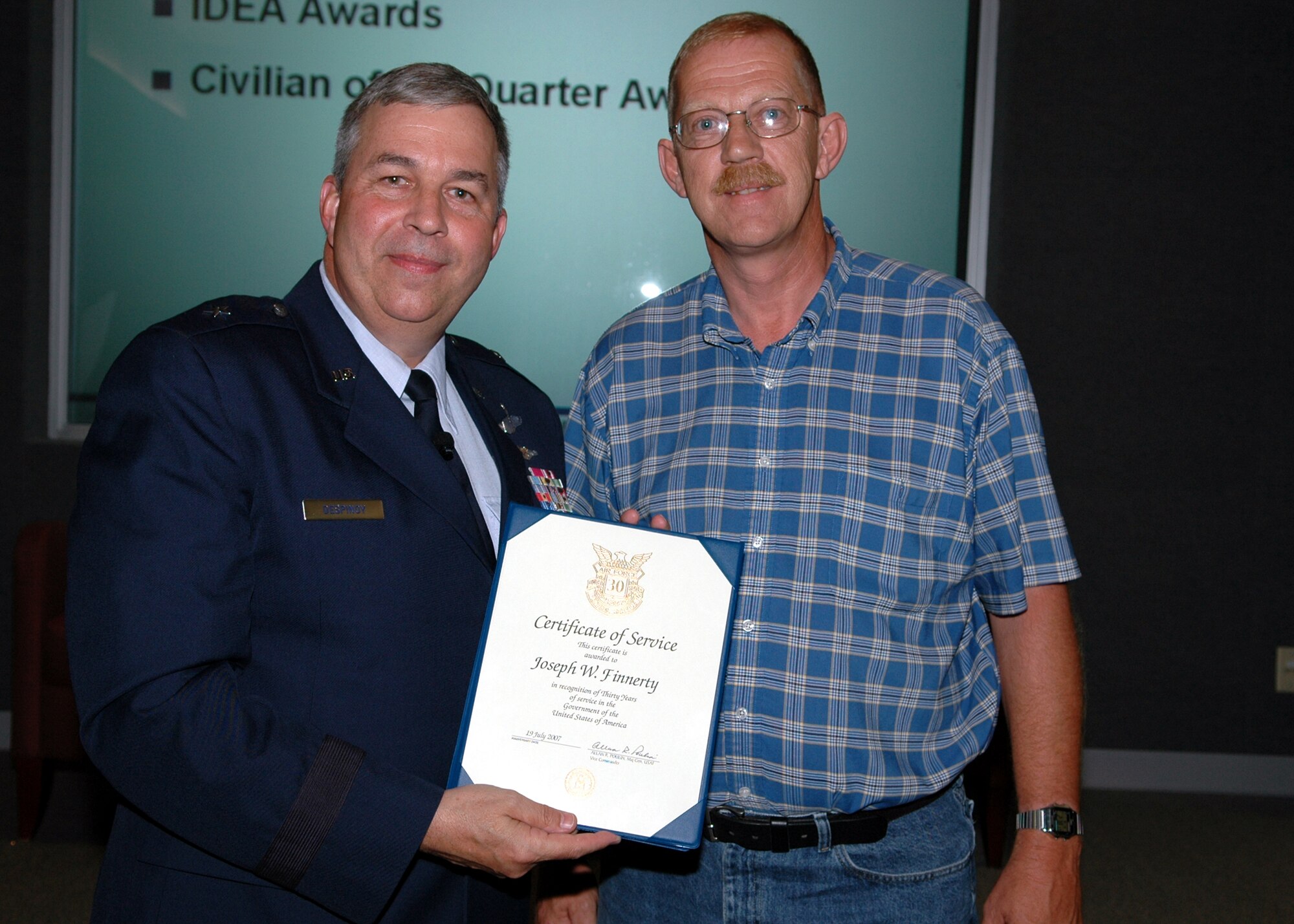 GRISSOM AIR RESERVE BASE, Ind., -- Brig. Gen. Dean Despinoy, 434th Air Refueling Wing commander, left, presents a certificate and pin to Joseph Finnerty, 434th Communications Squadron, recognizing his 30 years of federal service. (U.S. Air Force photo/Tech. Sgt. Doug Hays)