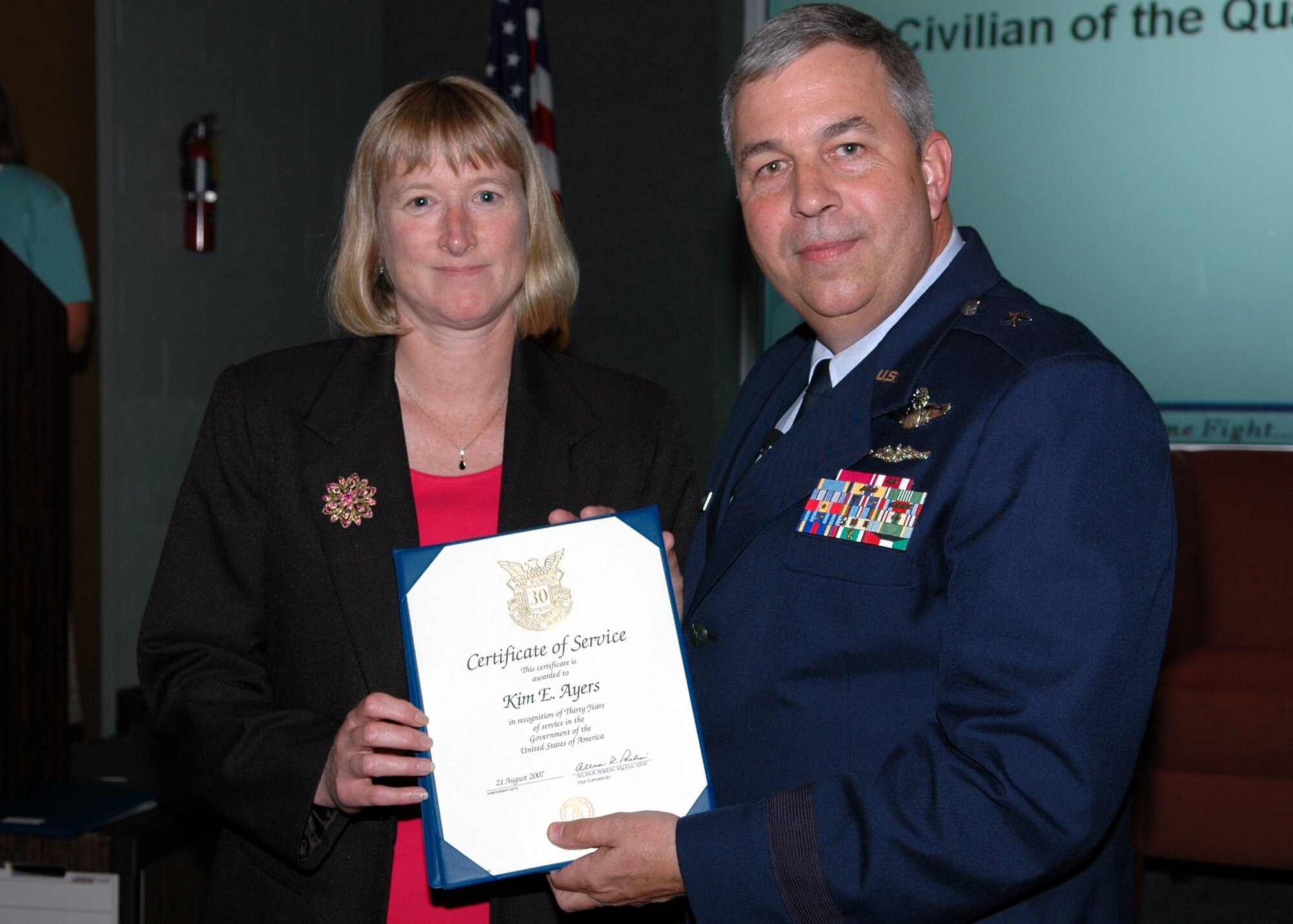 GRISSOM AIR RESERVE BASE, Ind., -- Brig. Gen. Dean Despinoy, 434th Air Refueling Wing commander, right, presents a certificate and pin to Kim Ayers, civilian personnel office, recognizing her 30 years of federal service. (U.S. Air Force photo/Tech. Sgt. Doug Hays)