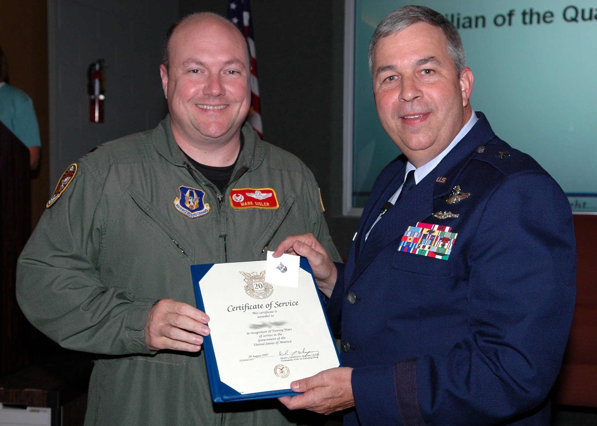 GRISSOM AIR RESERVE BASE, Ind., -- Brig. Gen. Dean Despinoy, 434th Air Refueling Wing commander, left, presents a certificate and pin to Lt. Col. Mark Sigler, 74th Air Refueling Squadron, recognizing his 20 years of federal service during a civilian commander's call recently. (U.S. Air Force photo/Tech. Sgt. Doug Hays)