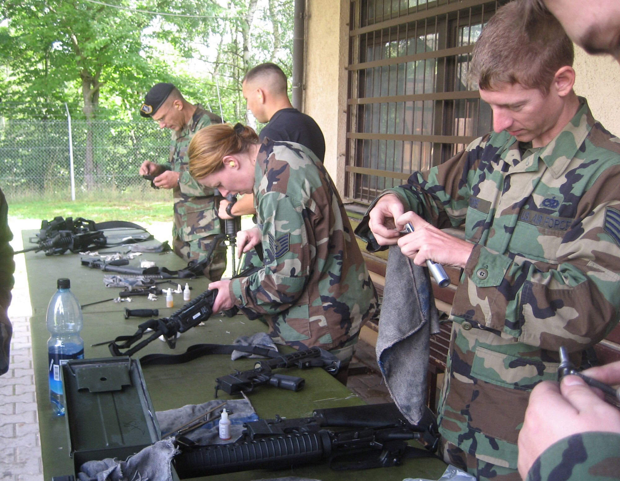 SPANGDAHLEM AIR BASE, Germany – Airmen from Spangdahlem Air Base clean their weapons after completing weapons qualification training at Baumholder Range, Germany, Aug. 16. More than 30 Airmen from Spangdahlem AB conducted weapons training at the range. (U.S. Air Force photo/Staff Sgt. Andrea Knudson)  