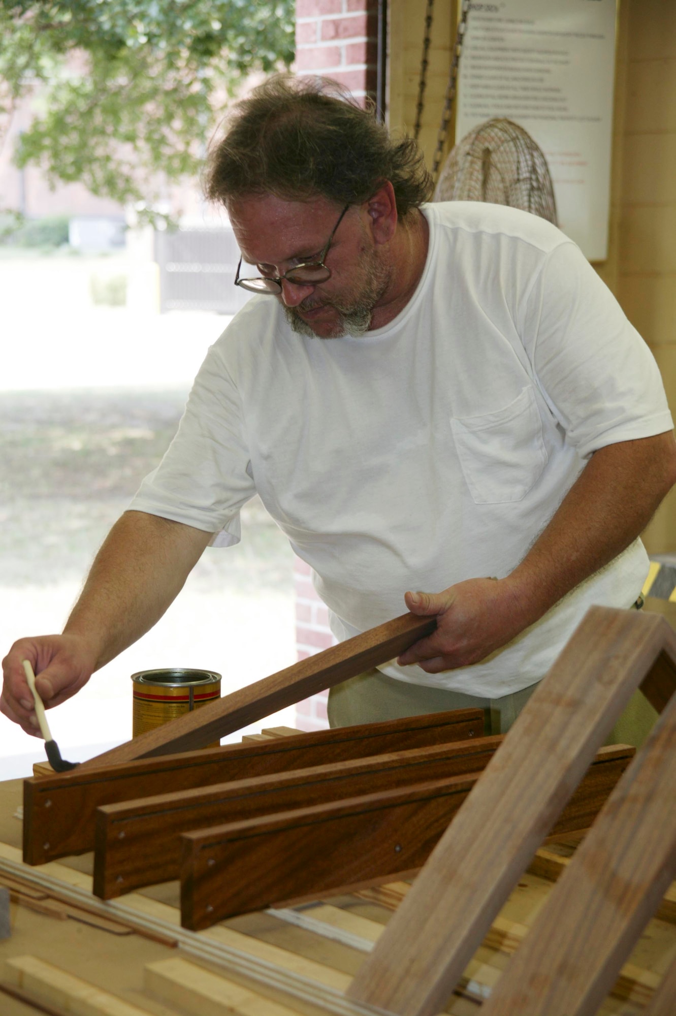 SHAW AIR FORCE BASE, S.C. -- Patrick McCammon, woodshop manager, stains wood pieces for a flag shadow box at the Arts and Crafts center woodshop Aug. 14. For more information about the Arts and Crafts center, visit http://www.20thservices.com/Arts_Crafts.html. (U.S. Air Force photo/ Senior Airman Holly MacDonald)
