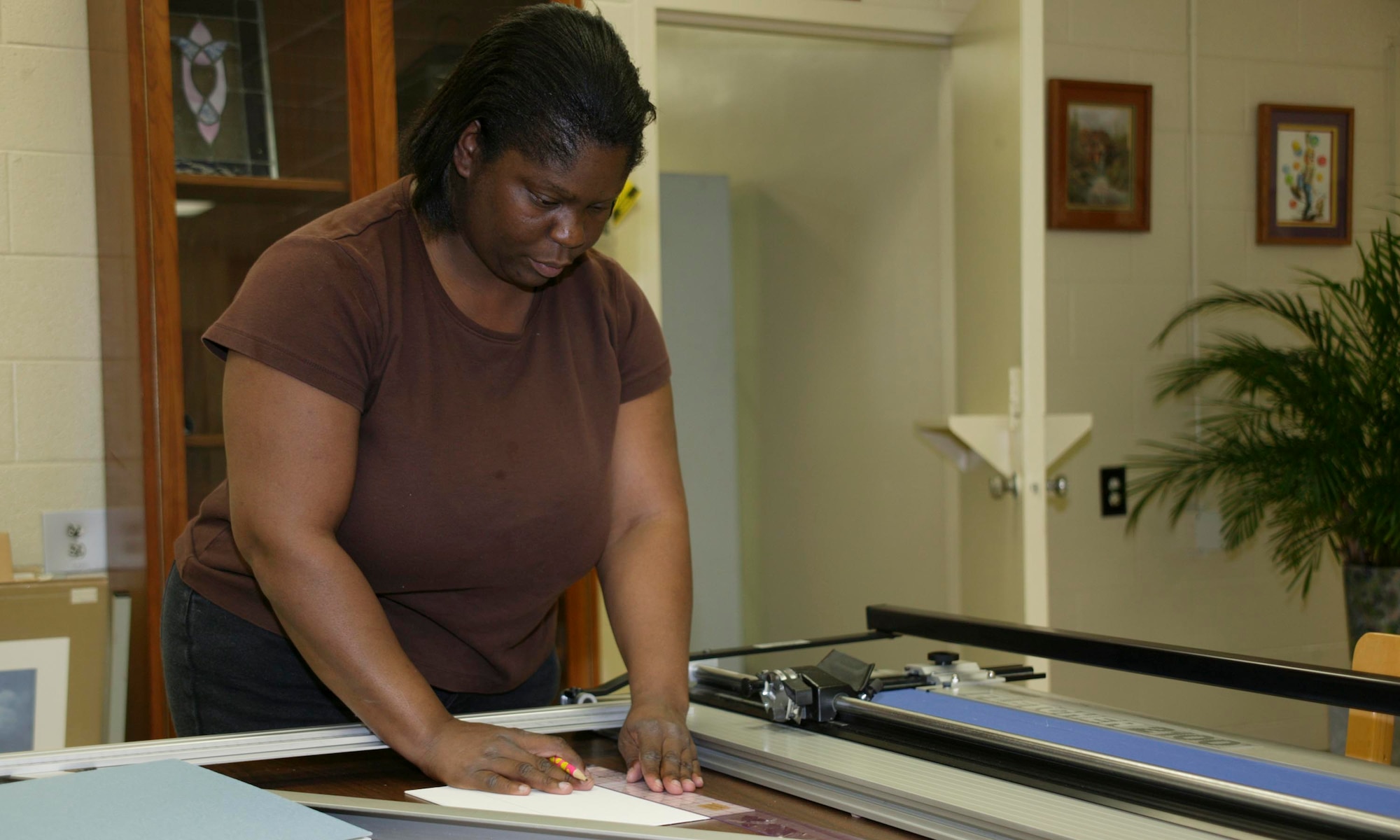 SHAW AIR FORCE BASE, S.C. -- Sybil Davis-Highdale, Arts and Crafts customer, measures matting to cut for a picture frame at the Arts and Crafts center Aug. 14. For more information about the Arts and Crafts center, visit http://www.20thservices.com/Arts_Crafts.html. (U.S. Air Force photo/ Senior Airman Holly MacDonald)