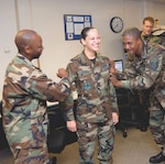 Sr. Airman Jessica Sherrod (center) of the 12th Comptroller Squadron gets her staff sergeant rank “pinned on” by Maj. Kerry Britt (left) and Senior Master Sgt. Bryan Anderson Wednesday. Airman Sherrod celebrated her birthday the same day she received word of her promotion. (Photo by Melissa Peterson)