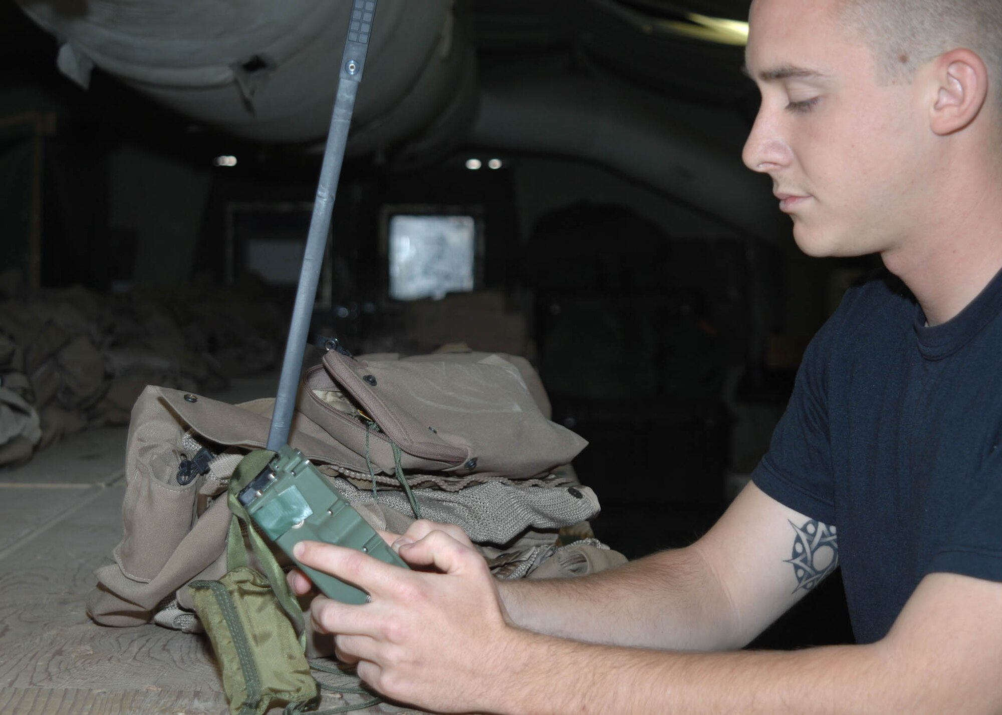 Senior Airman David Clark, 774th Expeditionary Airlift Squadron Life Support, configures a PRC 112 radio to complete an aircrew survival vest at Bagram Airfield, Afghanistan. Airman Clark is responsible for the inspection and preparation of all life support items needed for aircrew members deployed to Bagram in support of Operation Enduring Freedom. (U.S. Air Force photo by Senior Master Sgt. Kim Allain)