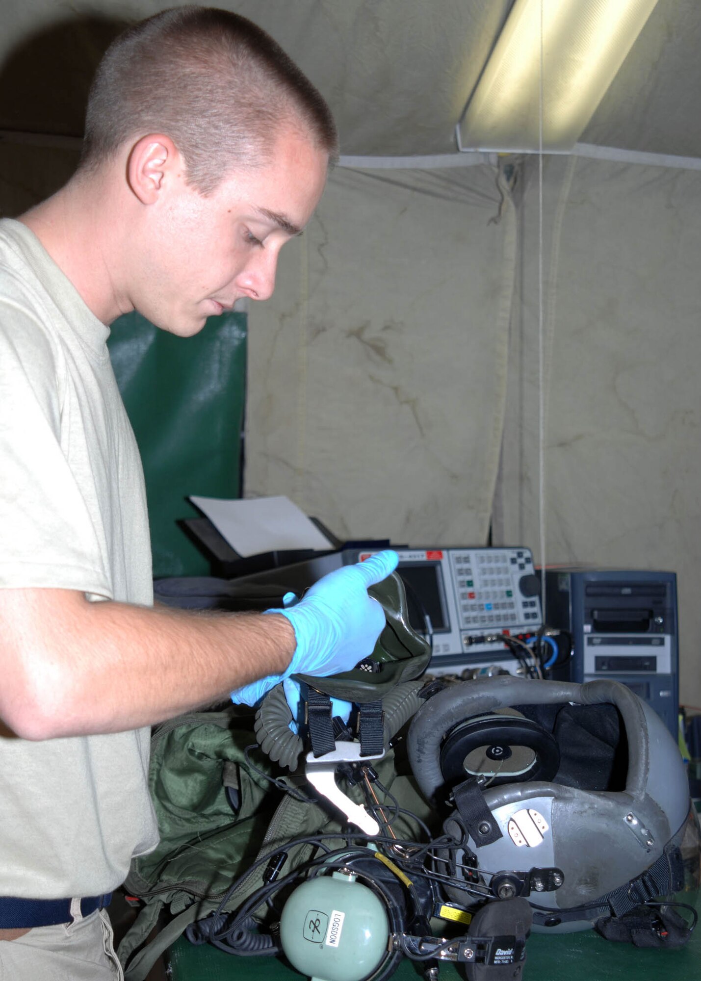 Senior Airman David Clark, 774th Expeditionary Airlift Squadron Life Support, builds a flight helmet at Bagram Airfield, Afghanistan. Airman Clark is responsible for the inspection and preparation of all life support items needed for aircrew members deployed to Bagram in support of Operation Enduring Freedom. (U.S. Air Force photo by Senior Master Sgt. Kim Allain)