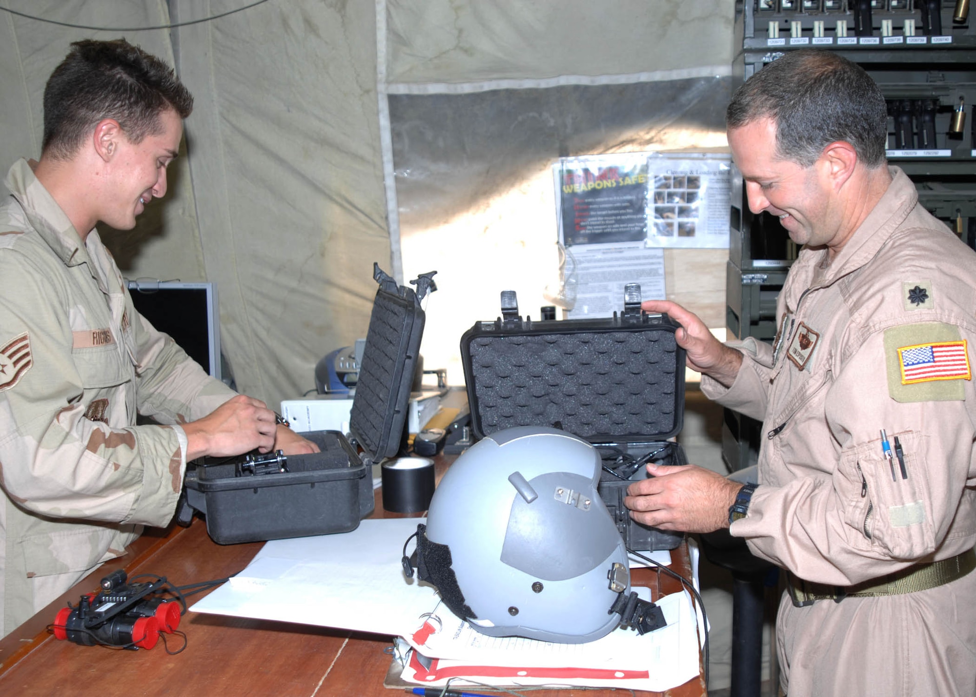 Staff Sergeant Michael Riggins (left), 774th Expeditionary Airlift Squadron Life Support, issues a helmet and night vision goggles to Lt. Col. Tom Esposito (right), a C-130 Hercules pilot with the 774th Expeditionary Airlift Squadron at Bagram Airfield, Afghanistan. Sergeant Riggins is responsible for the inspection and preparation of all life support items needed for aircrew members deployed to Bagram in support of Operation Enduring Freedom. (U.S. Air Force photo by Senior Master Sgt. Kim Allain)