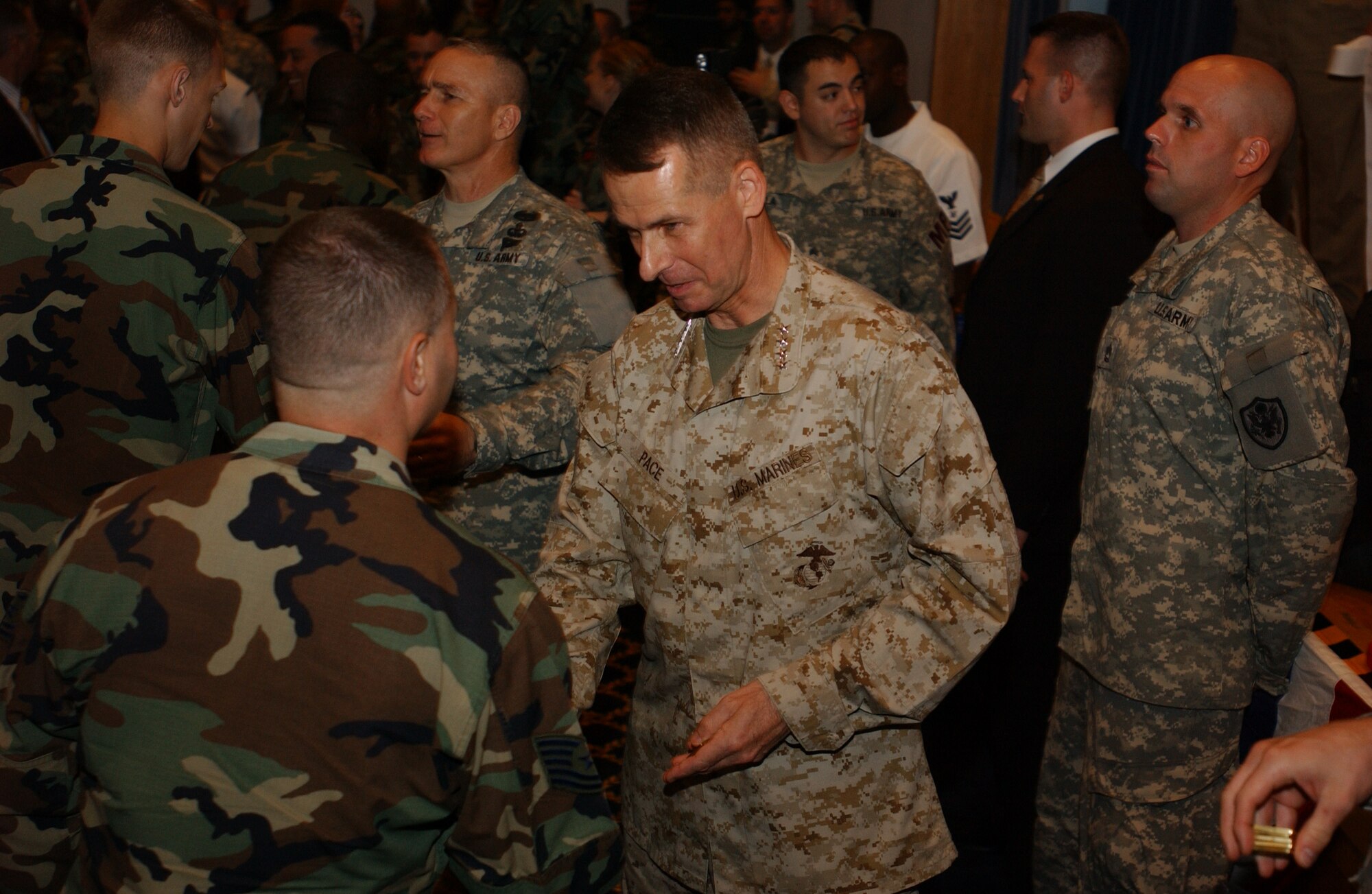 YOKOTA AIR BASE, JAPAN - General Peter Pace, Chairman of the Joint Chiefs of Staff, presents a coin to a U.S. Air Force Technical Sergeant during a Yokota Air Base Town Hall meeting on August 17, 2007.  General Pace was presenting coins to all service members in attendance who where E-7 and below. (U.S. Air Force photo by Airman First Class Jonathan Fowler)