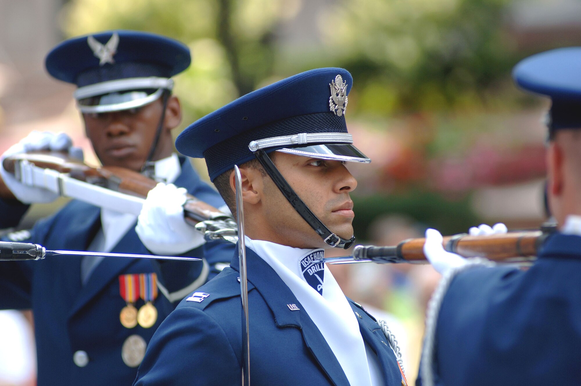 Capt. Joshua Hawkins, drill commander of the United States Air Force Honor Guard Drill Team, maintains focus and bearing for a maneuver that has four sharp bayonets pointed at his neck during a performance at a proclamation ceremony for Air Force Week New England in Boston Aug. 17. The drill team is the traveling component of the Air Force Honor Guard and tours worldwide showcasing the precision of today's Air Force to recruit, retain and inspire Airmen. (U.S. Air Force photo/Staff Sgt. Bennie J. Davis III) 