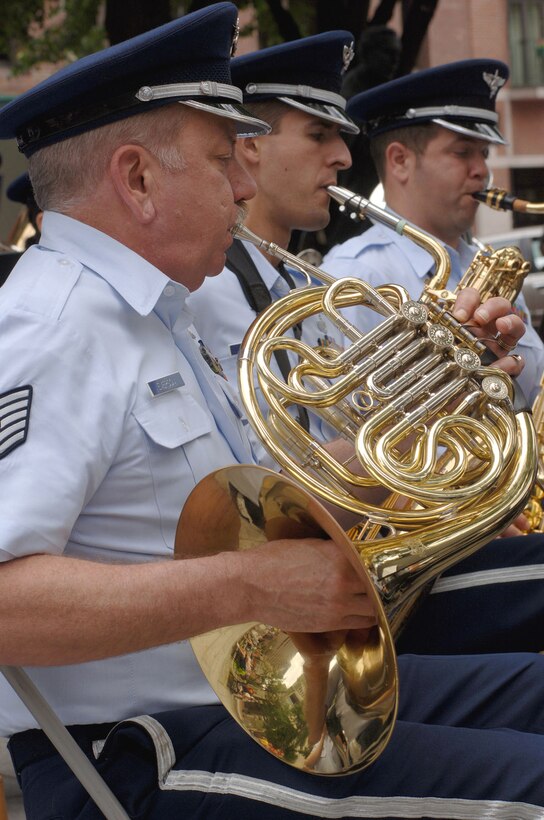 Tech. Sgt. Jim Emerson, a seven-year veteran of the Air National Guard Band of the Northeast, plays the French horn during a proclamation ceremony for Air Force Week New England in front of historic Faneuil Hall in downtown Boston Aug. 17. Sergeant Emerson is a National Guard member who lives in Florida, works in China and drills with the band out of Milford, Mass. (U.S. Air Force photo/Staff Sgt. Bennie J. Davis III)