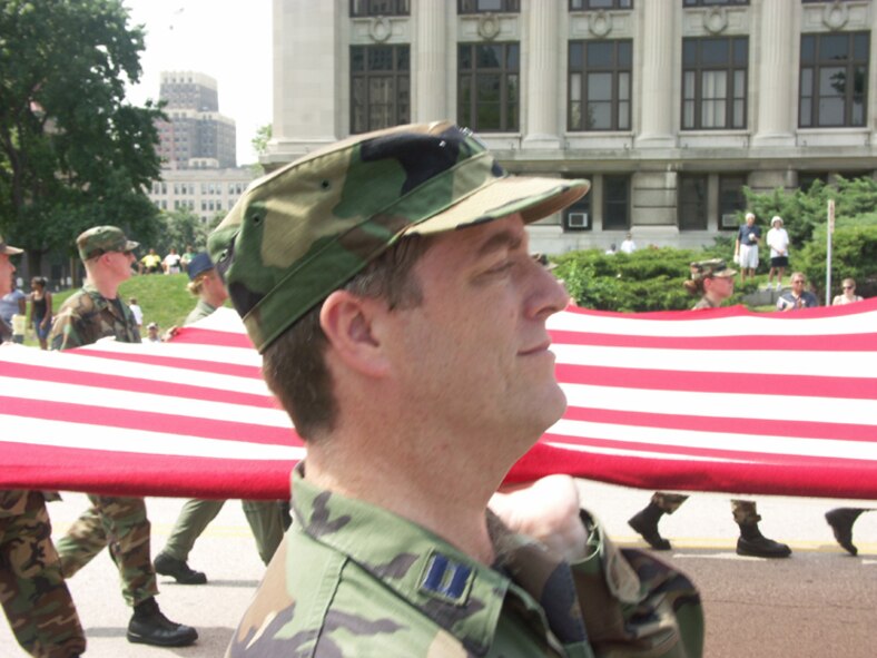932nd Airlift Wing marches....and Chaplain Bell smiles going down the Market Street in St. Louis July 4, 2007.  Photo by Tech Sgt. Danny Oliver.