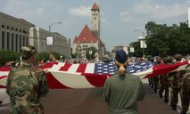 932nd Airlift Wing marches with Sergeants "Dan" and "Liz" holding the back end of the American flag on Independence Day, 2007 in Saint Louis.