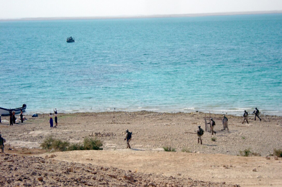 HADITHA DAM, Iraq, (Sept. 16, 2007) – Sailors with the MIO team attached to Detachment 3, Riverine Squadron 1, Riverine Group 1, Navy Expeditionary Combat Command, in support of Regimental Combat Team 2, sweep across one of the many islands along the Euphrates River, searching civilians for any illegal weapons or explosives. To prepare for the deployment, the Navy sent all the sailors in the squadron to special schools to train in what would usually be considered as infantry roles. Photo Courtesy of Riverine Squadron 1.