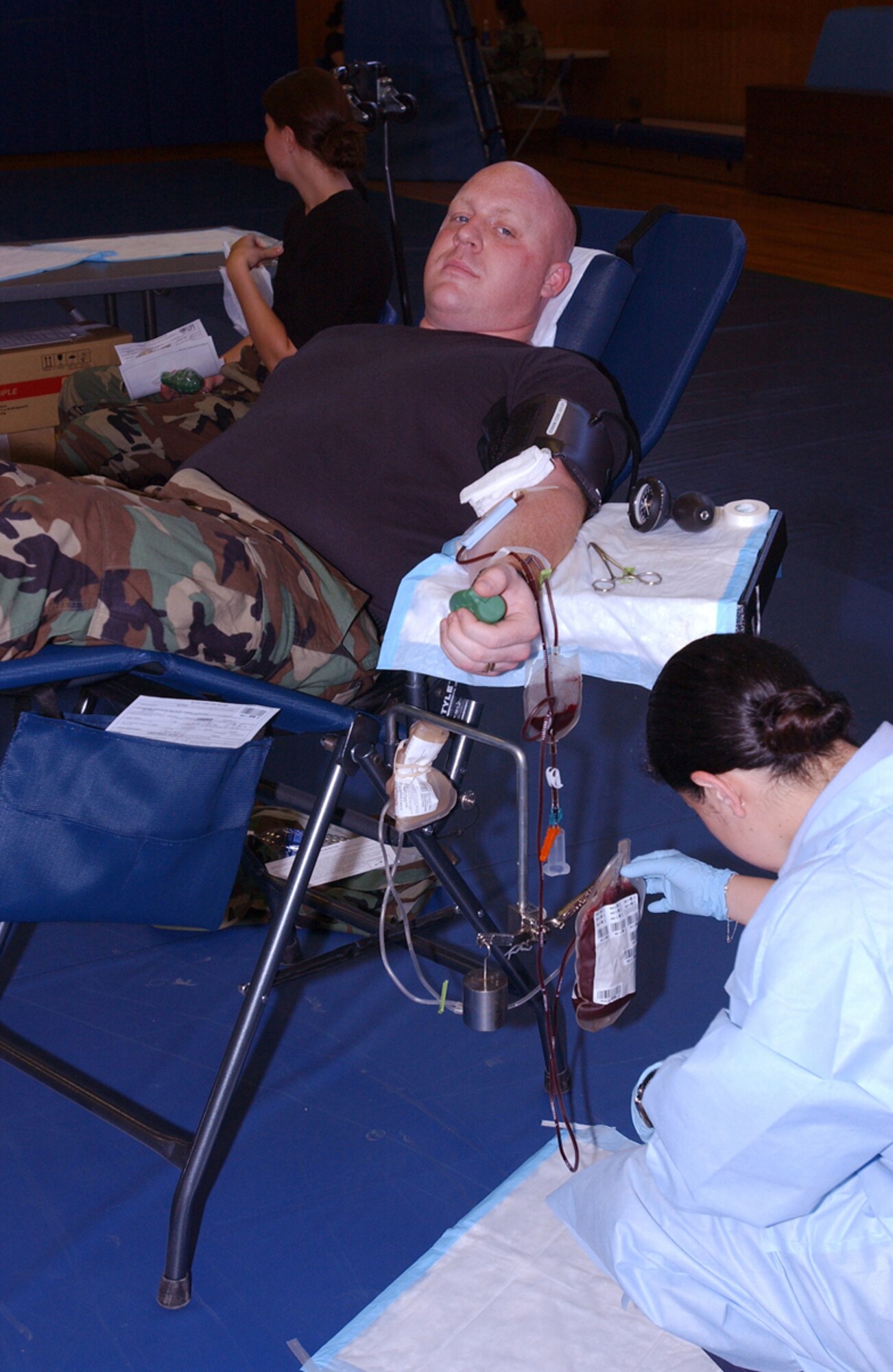 MISAWA AIR BASE Japan -- Staff Sgt. Daniel Mayo, 35th Maintenance Group, gets his blood drawn by Hospital Corpsman 3rd Class Rinda Arias on Misawa Air Base, Japan, Aug.15, 2007. The blood drive held in Misawa collected 105 units of blood. (U.S. Air Force photo by Airman 1st Class Benjamin Wilson)