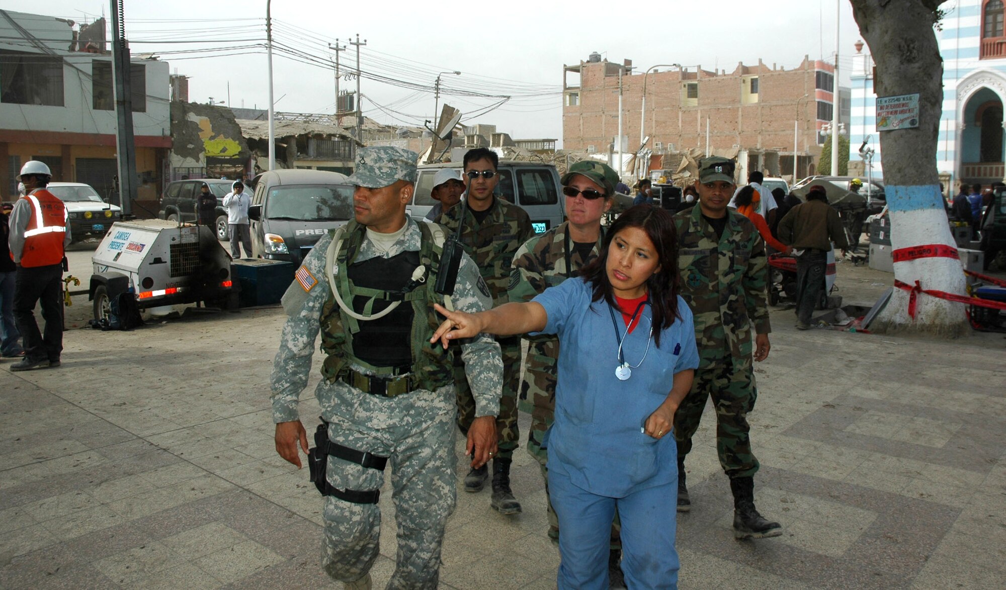 Army Private 1st Class David Torres gets information Aug. 19 on the town of Pisco, Peru, from local paramedic Maricarmen Perez  during Joint Task Force-Bravo's medical humanitarian mission. Members of JTF-Bravo at Soto Cano Air Base, Honduras, traveled to Peru to assist in relief following the 8.0 magnitude earthquake which struck the region Aug. 15. Private Torres is a security forces member with JTF-B. (U.S. Army photo/Spc. Grant Vaught)