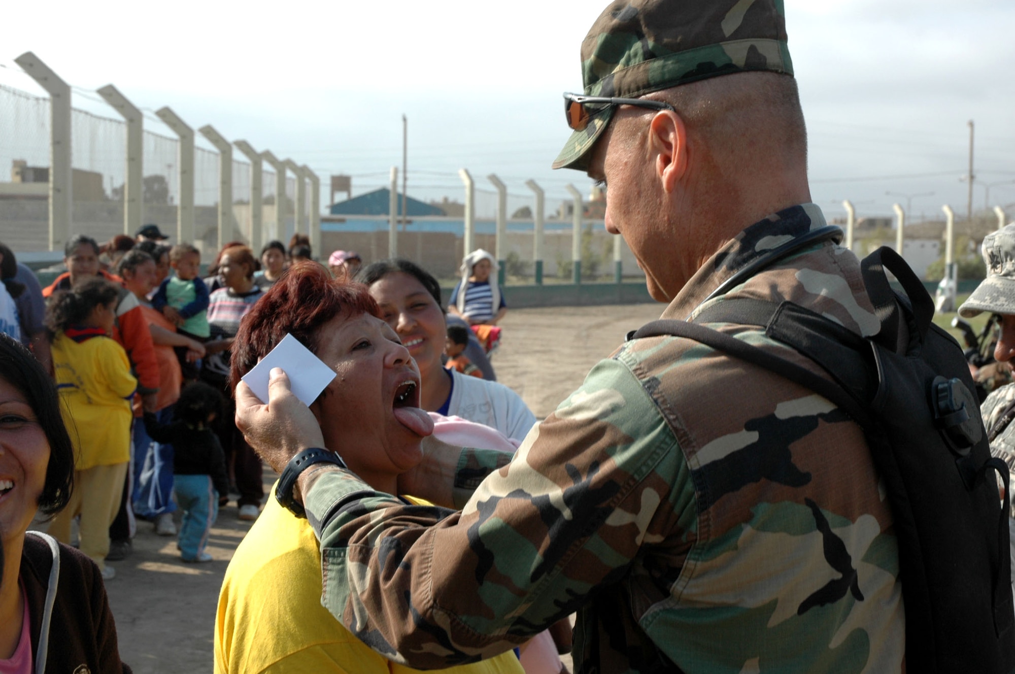 Maj. Joseph Hallock provides an oral exam to a patient Aug. 18 during the Joint Task Force-Bravo's medical humanitarian mission to Pisco, Peru, following an 8.0 magnitude earthquake that devastated the region Aug. 15.  At the medical site, personnel provided basic medical care and medicine to more than 500 people the first two days of the mission. Major Hallock is a pediatric nurse practitioner for JTF-B's Medical Element at Soto Cano Air Base, Honduras. (U.S. Army photo/Spc. Grant Vaught)