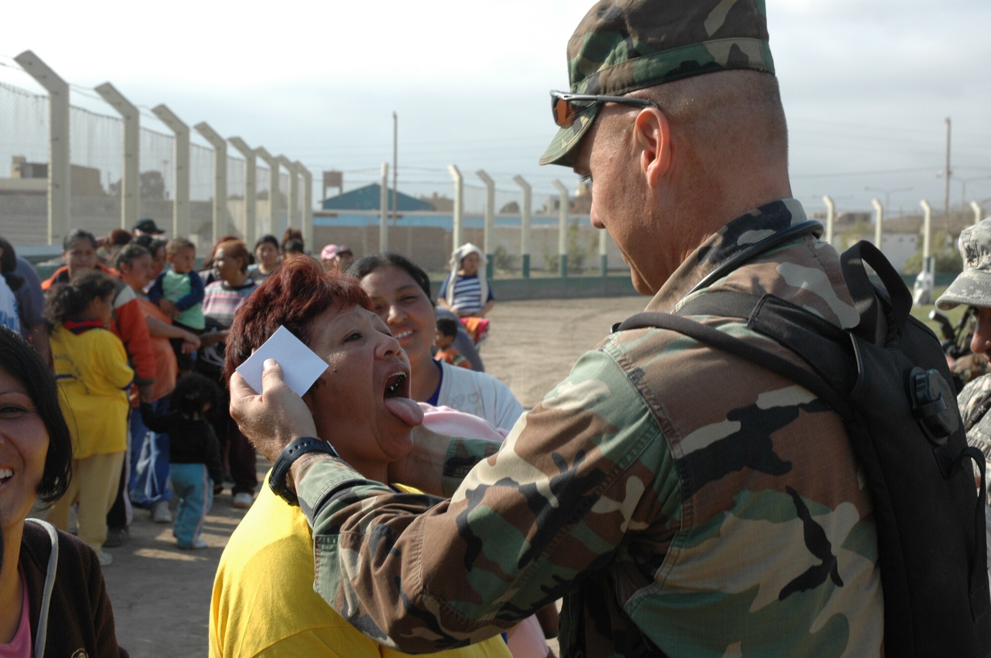 PISCO, Peru -- Air Force Maj. Joseph Hallock, a pediatric nurse practitioner for Joint Task Force-Bravo’s Medical Element at Soto Cano Air Base, Honduras, provides an oral exam to a patient during the task force’s medical humanitarian mission to Pisco following an 8.0 magnitude earthquake that devastated the region Aug. 15.  At the medical site personnel provide basic medical care and medicines to more than 500 people the first two days of the mission. (U.S. Army photo by Spec. Grant Vaught)