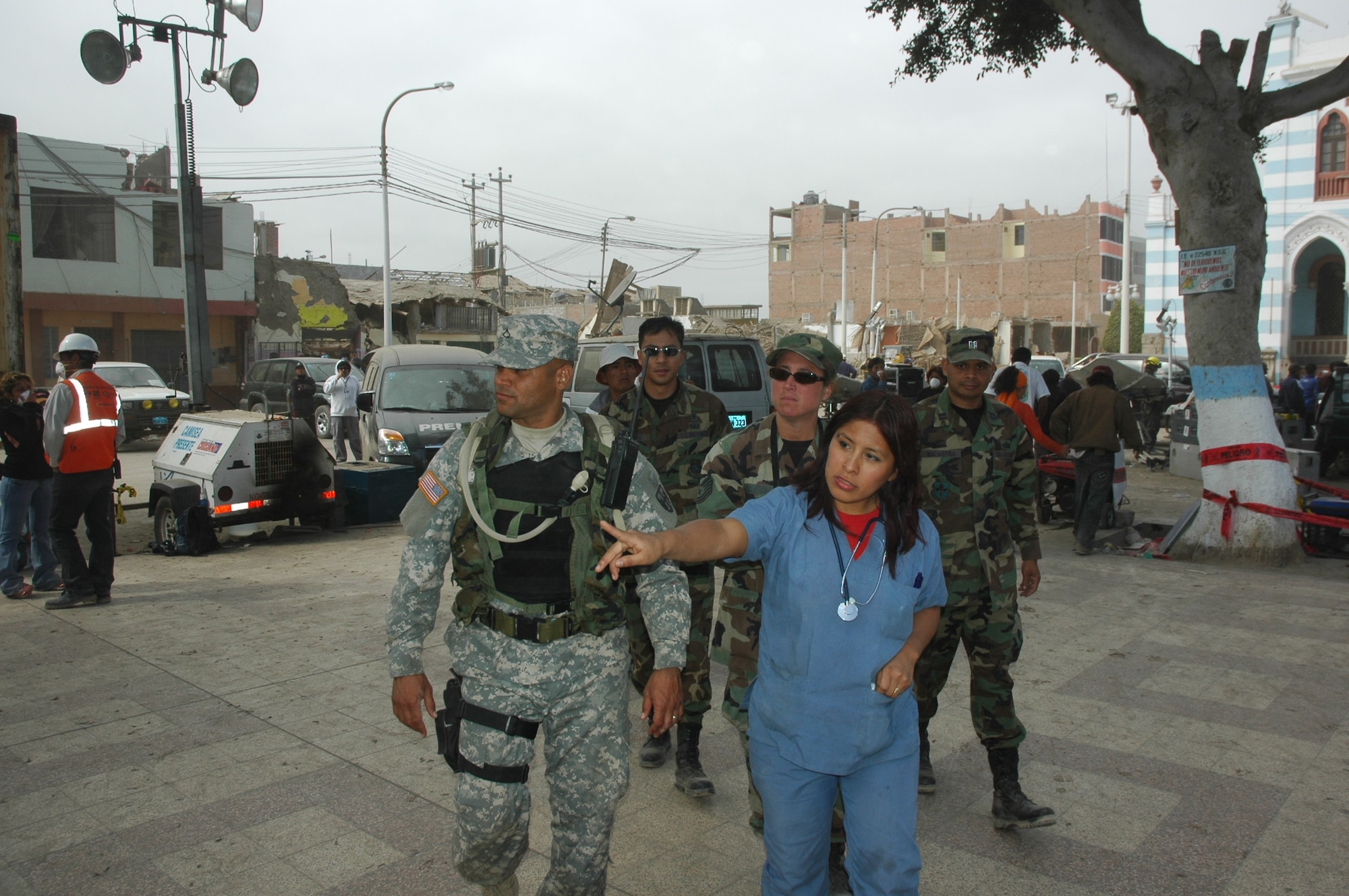 PISCO, Peru -- Army Private 1st Class David Torres, Joint Task Force-Bravo Joint Security Forces member, gets information on the town of Pisco from Maricarmen Perez, a local paramedic during the Task Force’s medical humanitarian mission. Members of JTF-Bravo, Soto Cano Air Base, Honduras, traveled to Peru to assist in relief following the 8.0 magnitude earthquake which struck the region Aug. 15.  (U.S. Army photo by Spec. Grant Vaught)