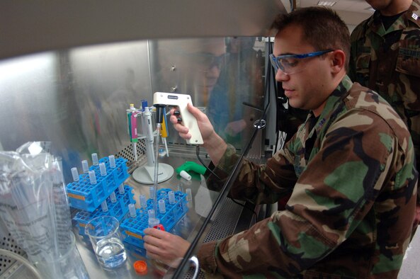Cadet 1st Class Brandon Martinez transfers bacteria from jet fuel into culture tubes in a laboratory at the U.S. Air Force Academy in Colorado Springs, Colo. The bacteria eat jet fuel and produce a slime that can foul jet engines. Academy cadets perform this research as part of their curriculum. (U.S. Air Force photo/John Van Winkle)