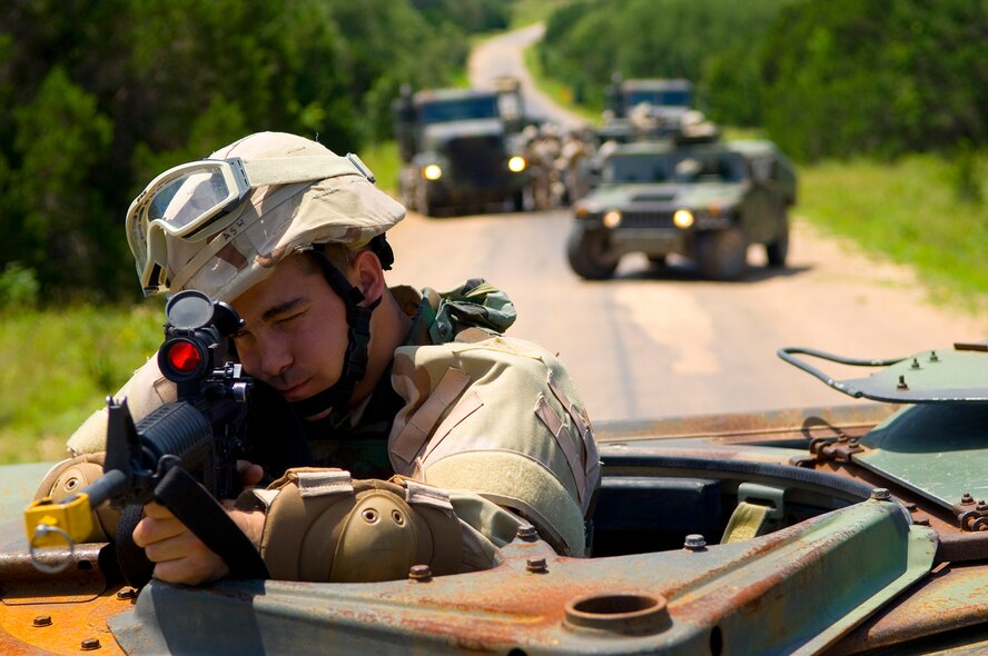 Vehicles form a “box,” much like circling the wagons, when under attack, while a “gunner,” such as Airman 1st Class Daniel Ash, a student from the 49th Logistic Readiness Squadron, Holloman AFB, N.M., protects the convoy. (photo by Tech. Sgt. Matthew Hannen)
