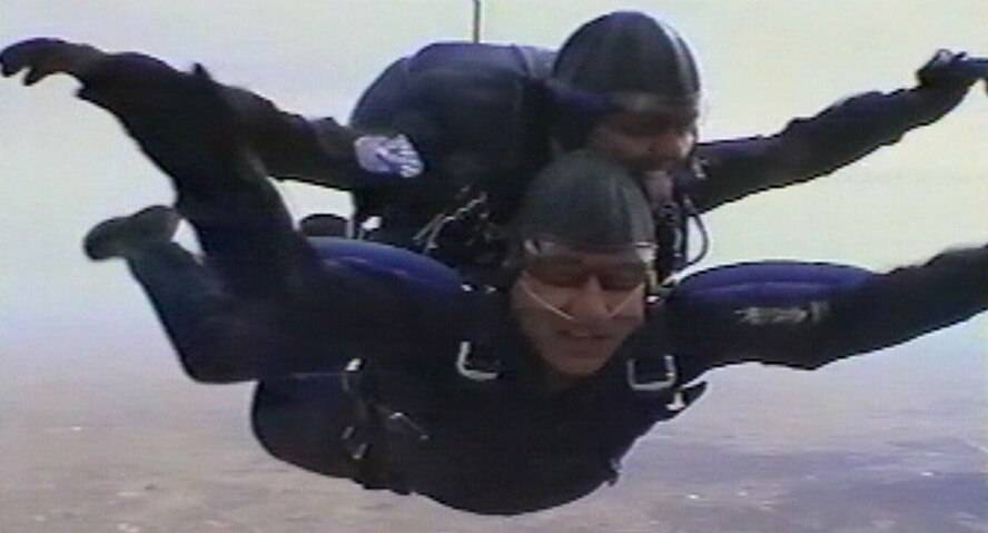 Maj. Alex Cos of the U.S. Air Force Academy’s Wings of Blue jump team escorted Col. John W. Blumentritt, AETC director of safety, via a tandem jump, from 17,500 feet above sea level to the tiny drop zone on the academy’s airfield.