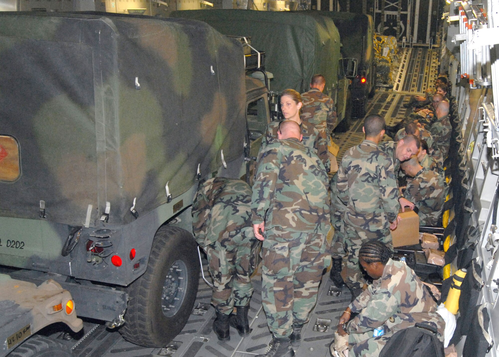 Members of the 43rd Aeromedical Evacuation Squadron at Pope Air Force Base, N.C., settle in on a C-17 Globemaster III for the trip to Brownsville, Texas, Aug. 19. Approximately 40 flight nurses, flight medics and support personnel deployed to set up a Mobile Aeromedical Staging Facility in preparation for Hurricane Dean relief efforts. (U.S. Air Force photo/Ed Drohan)